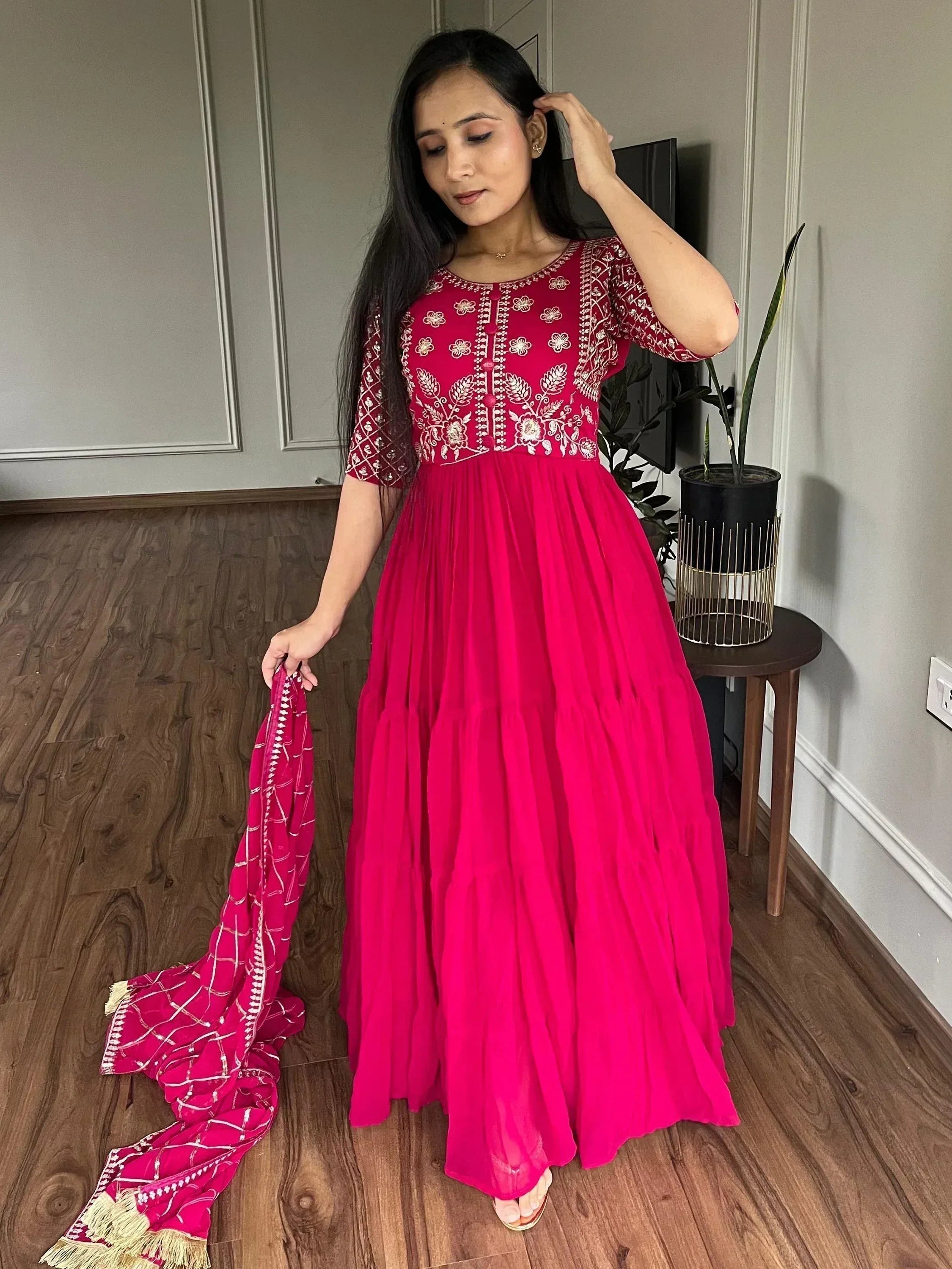 Fuchsia ethnic gown with white floral embroidery, paired with matching dupatta, ideal for Indian occasions
