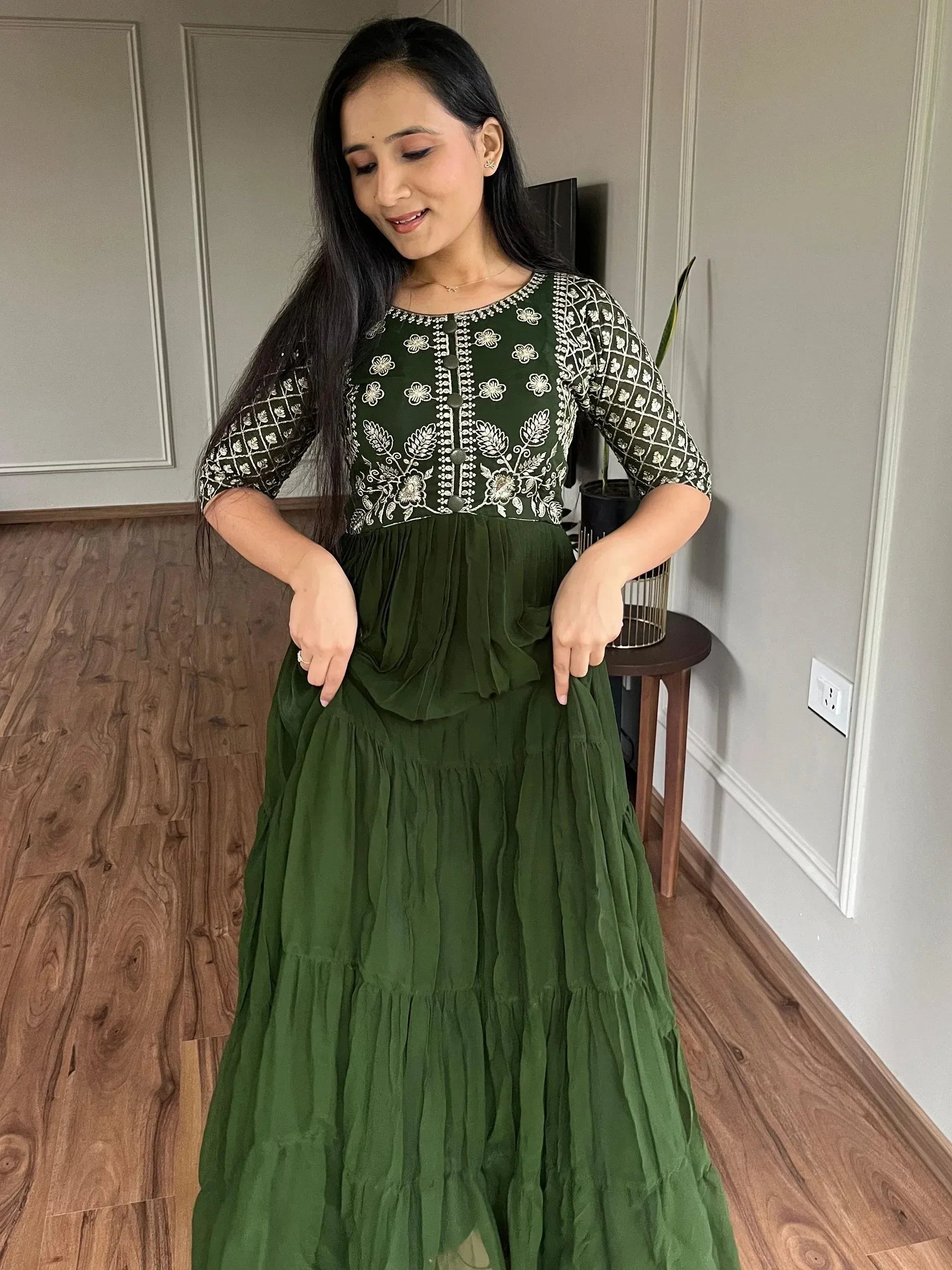 Green embroidered ethnic gown with floral patterns and tiered skirt