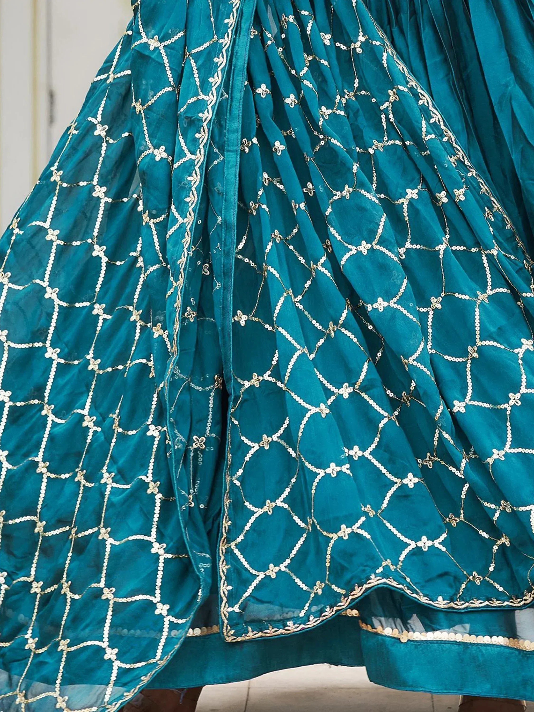 Teal ethnic gown with gold sequin embroidery and floral patterns