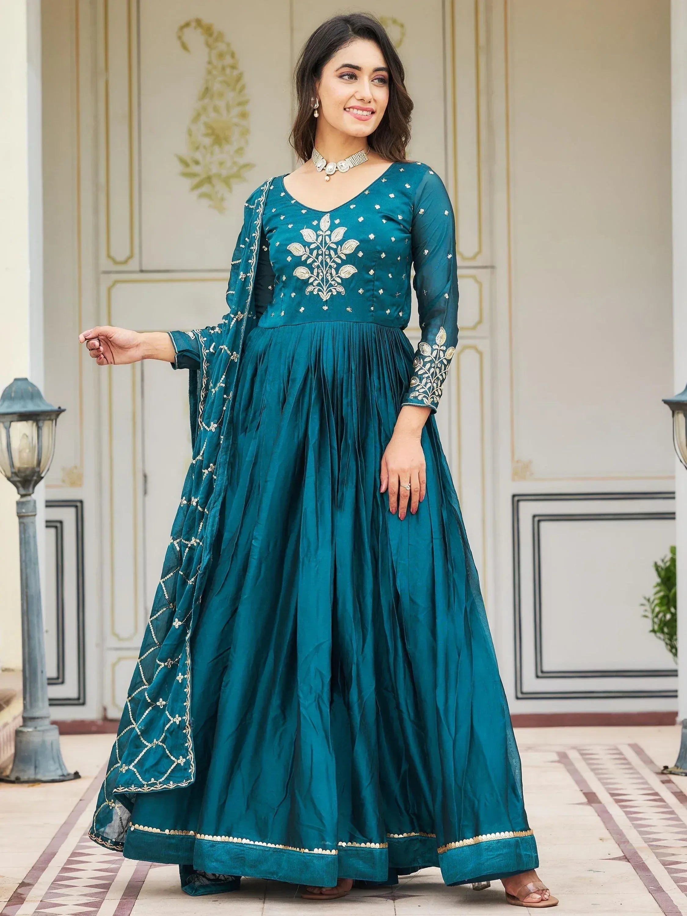 Teal ethnic anarkali gown with gold embroidery, perfect for Indian weddings and festive occasions.
