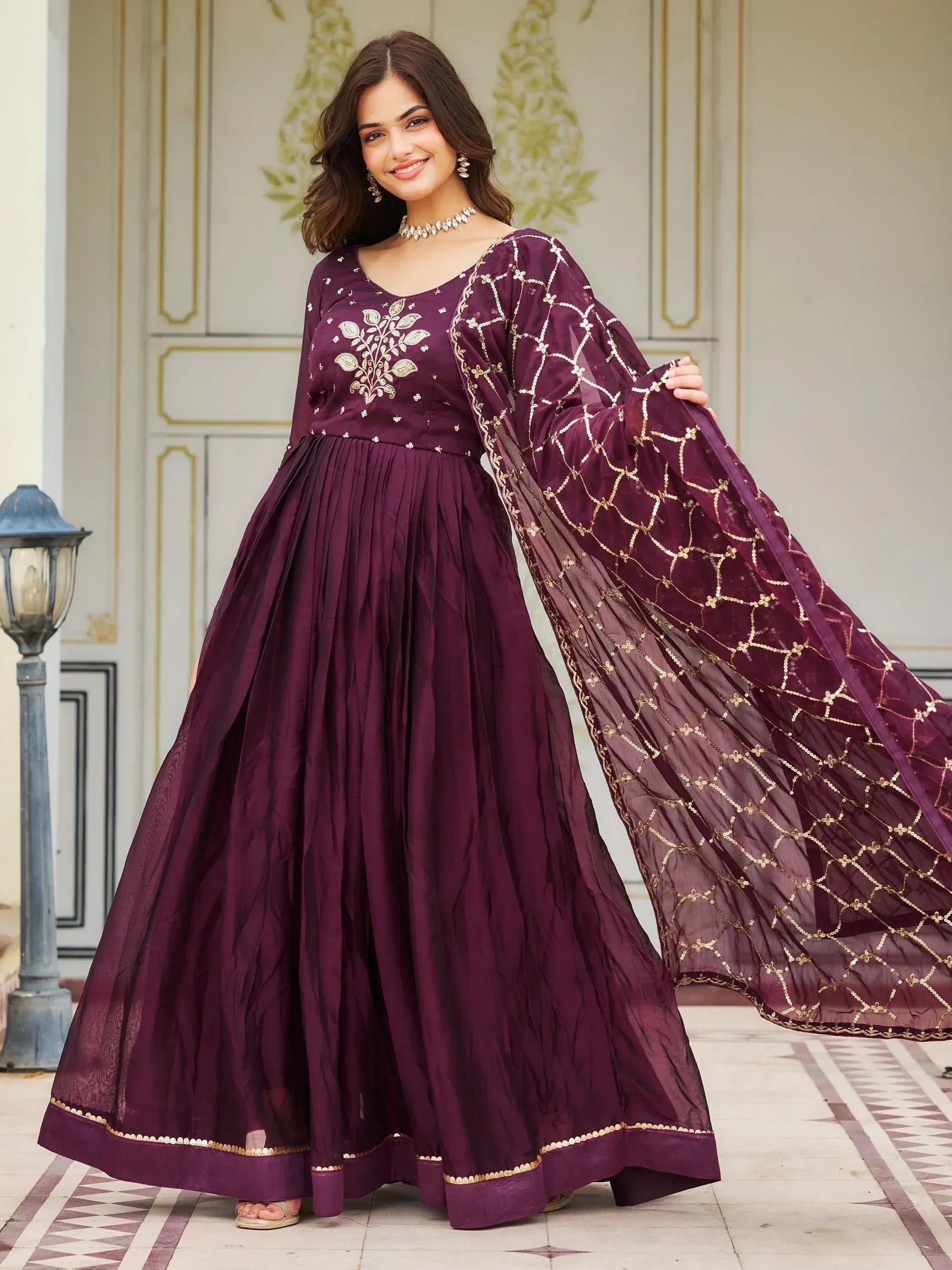 Elegant purple anarkali gown with gold embroidery and sheer dupatta, perfect for Indian ethnic occasions