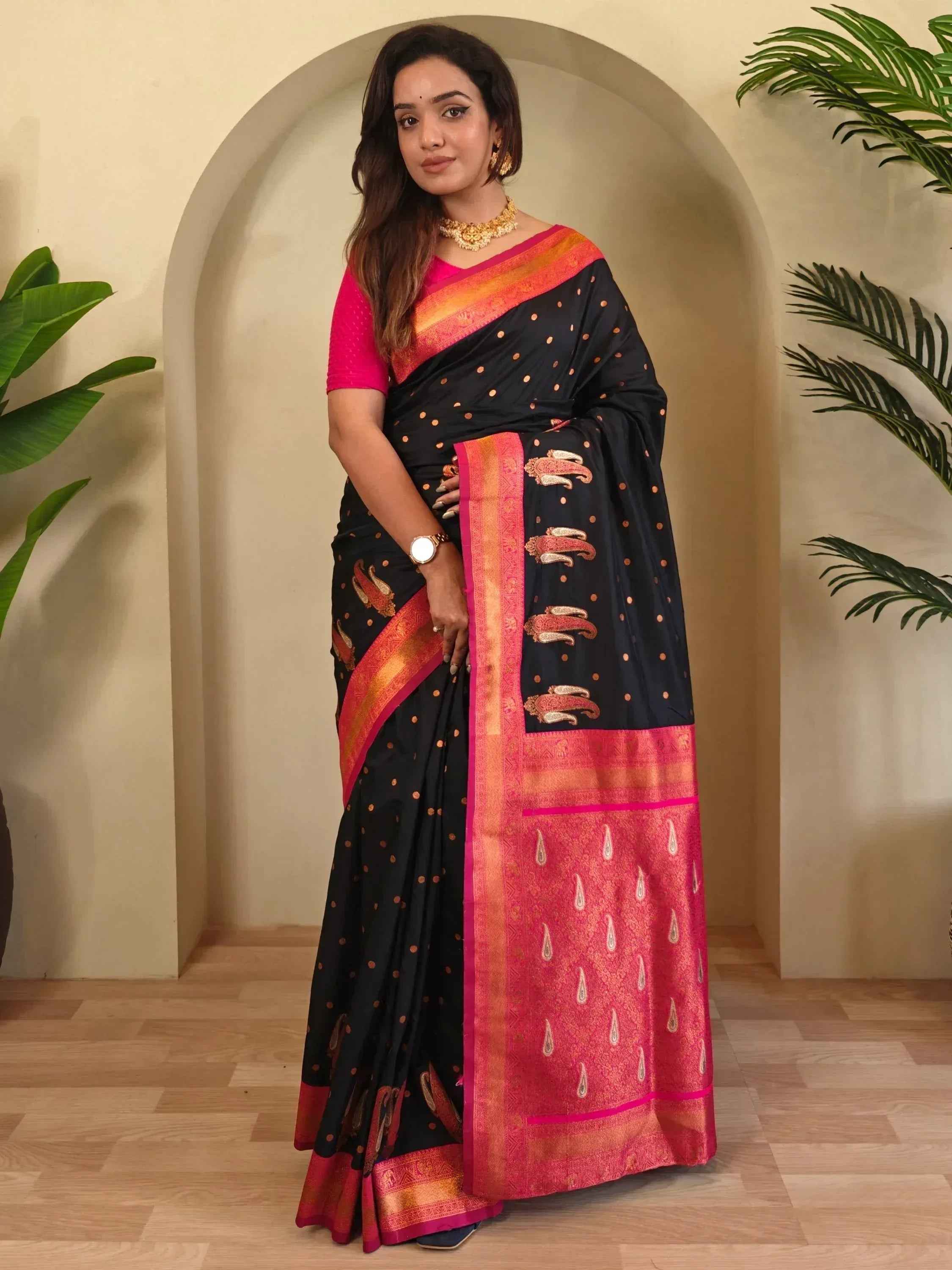 Black and pink designer saree with gold paisley and dot motifs, perfect for Indian ethnic wear