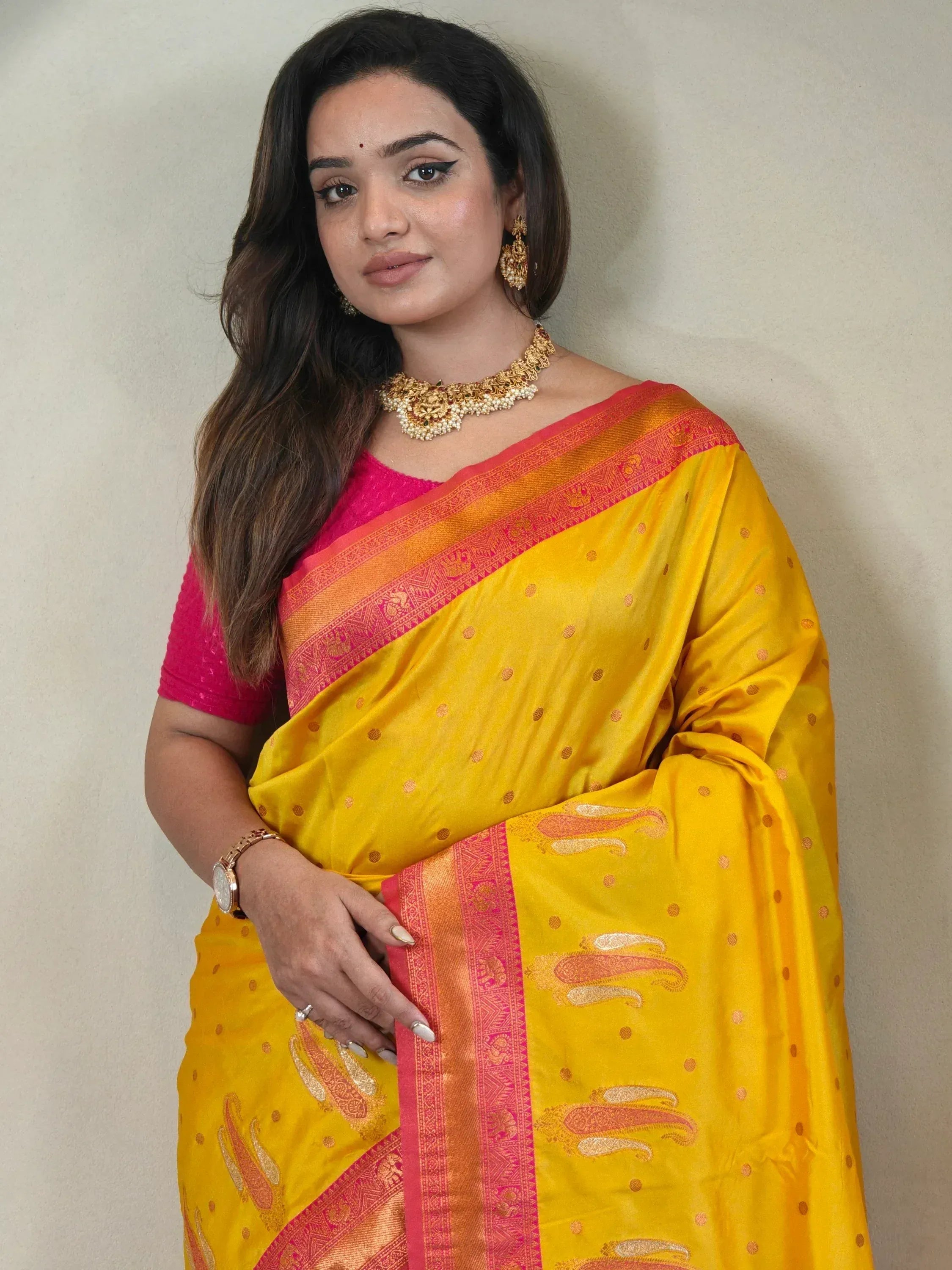 Yellow and pink designer saree with gold paisley print, perfect for Indian ethnic wear occasions.