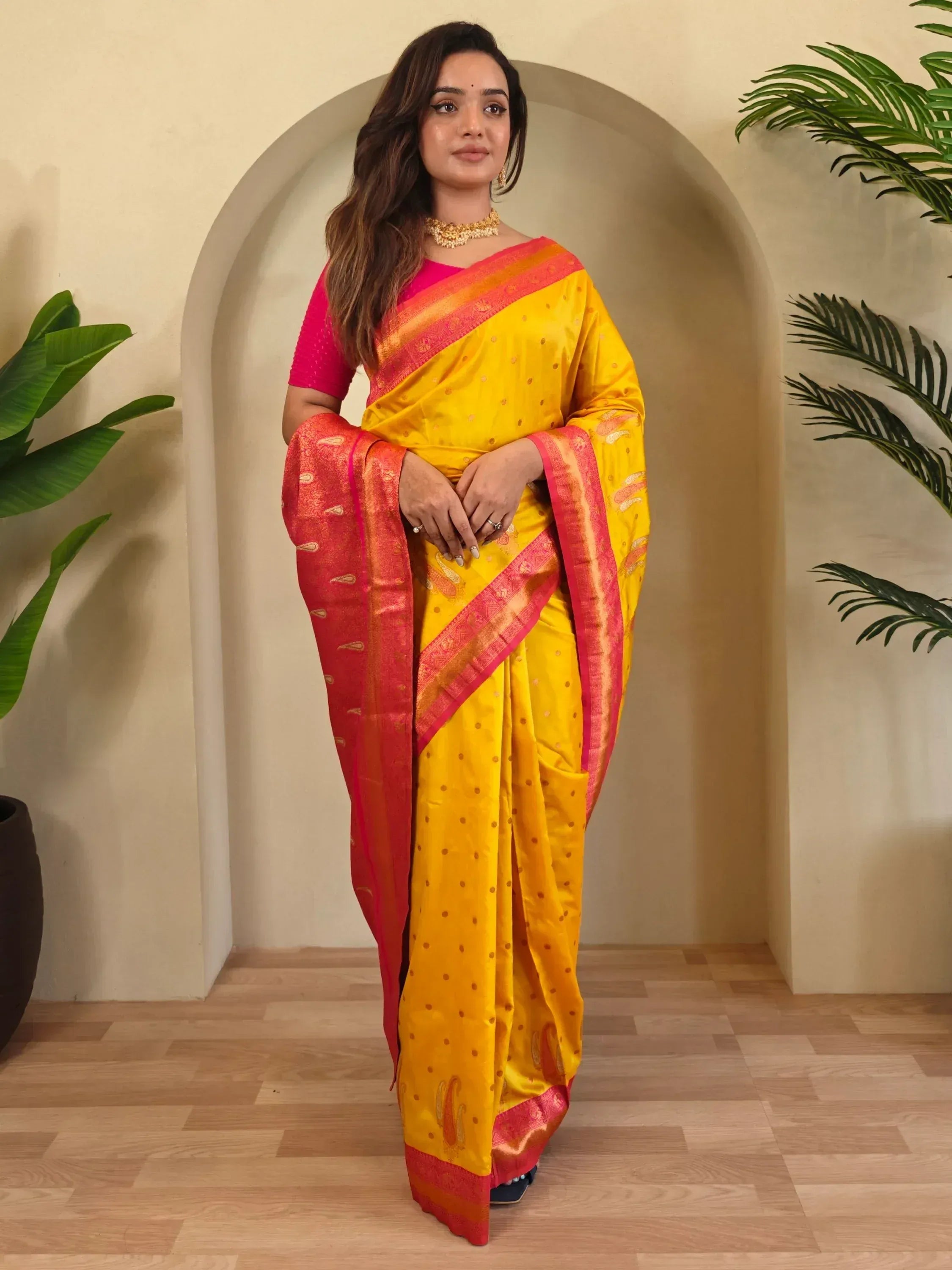 Yellow and pink ethnic saree with gold motifs, perfect for Indian occasions and festive wear.