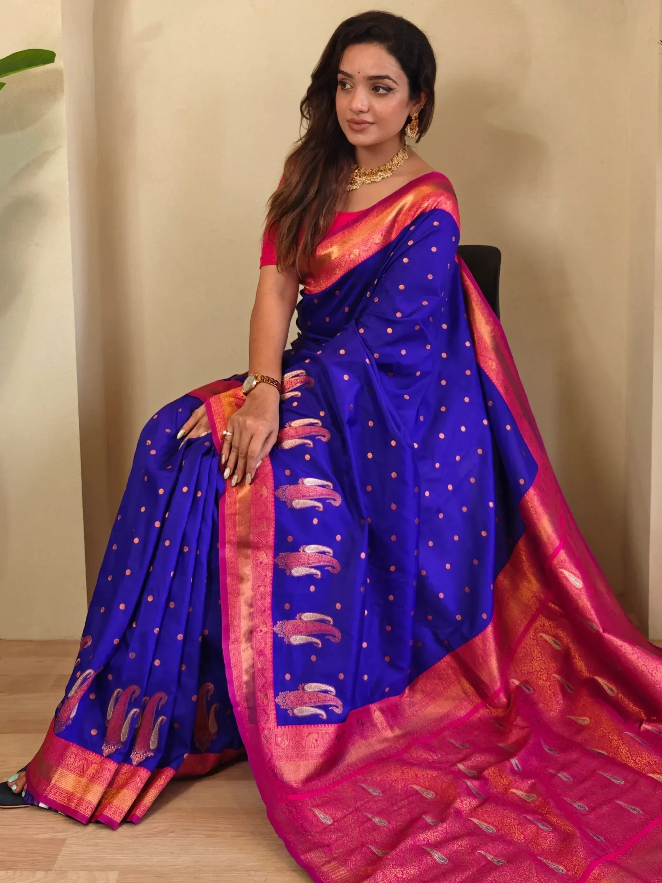 Royal blue silk saree with pink gold border, paisley motifs, and polka dots, paired with matching blouse for Indian ethnic wear