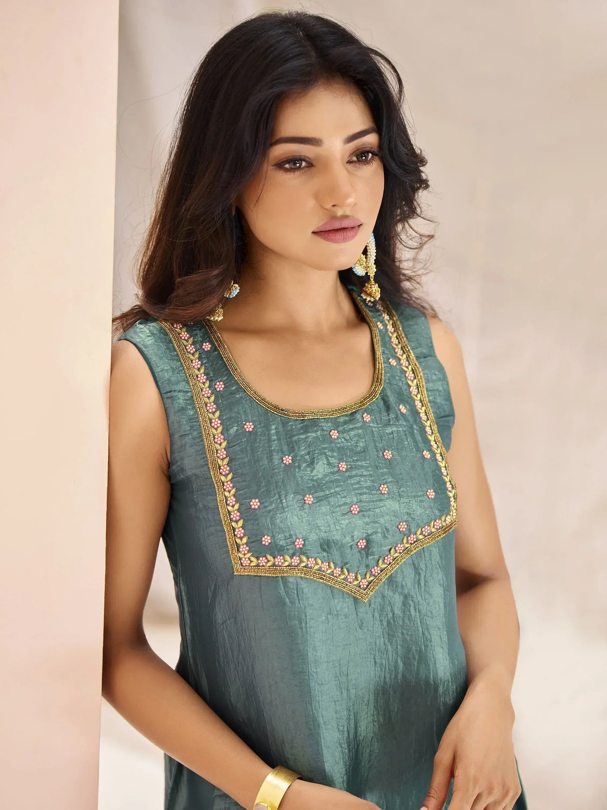 Teal sleeveless ethnic kurti with gold and pink floral embroidery, perfect for Indian wear