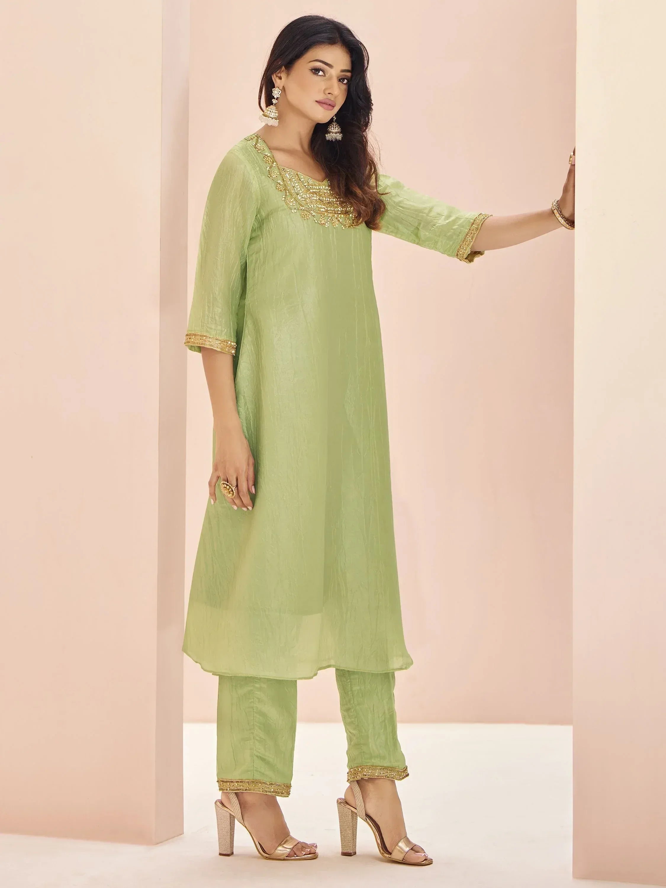 Light green ethnic kurta set with gold embroidery, perfect for festive occasions and traditional wear.