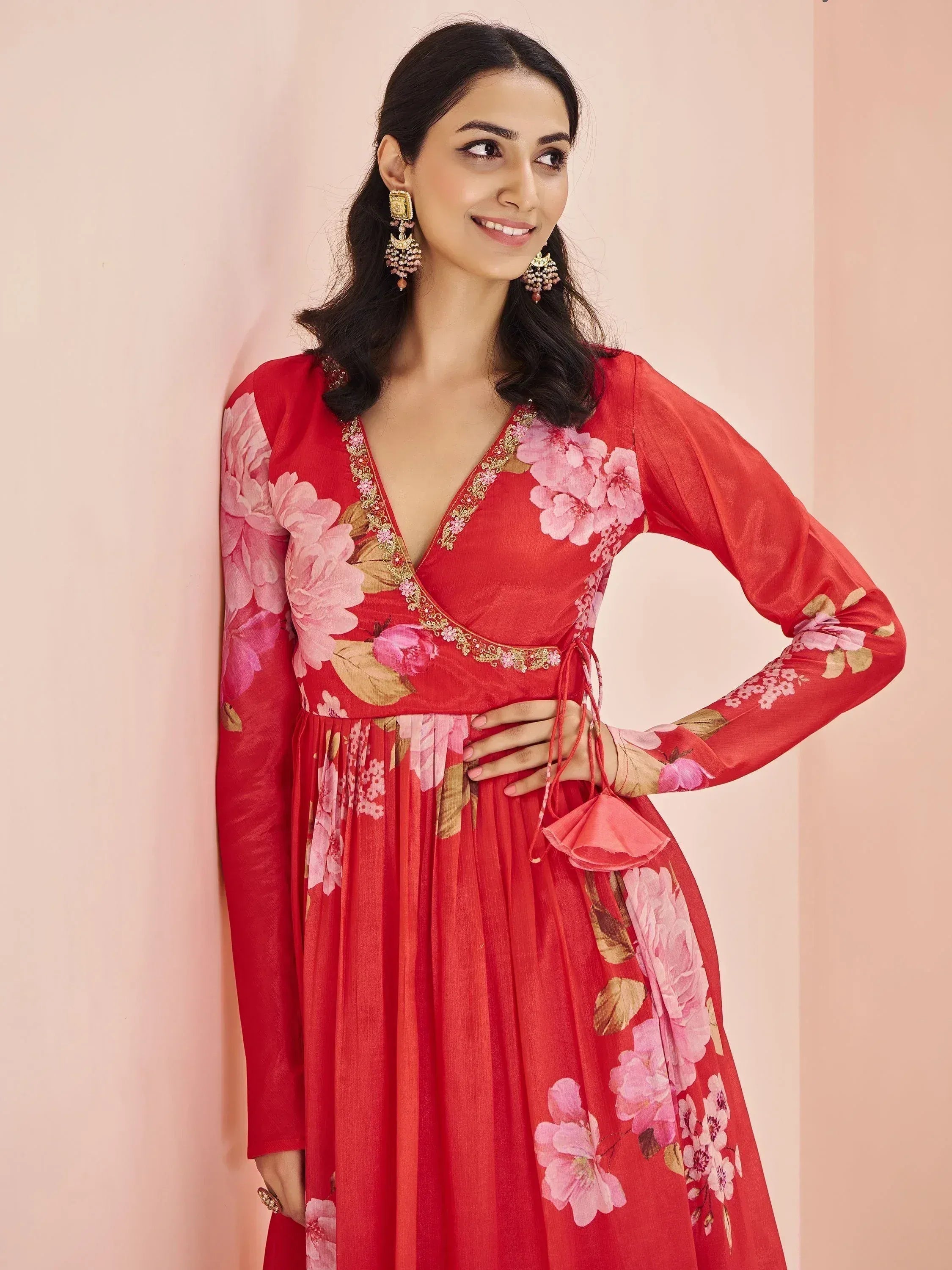 Red floral print ethnic gown with V-neck and gold embroidery, perfect for Indian occasions