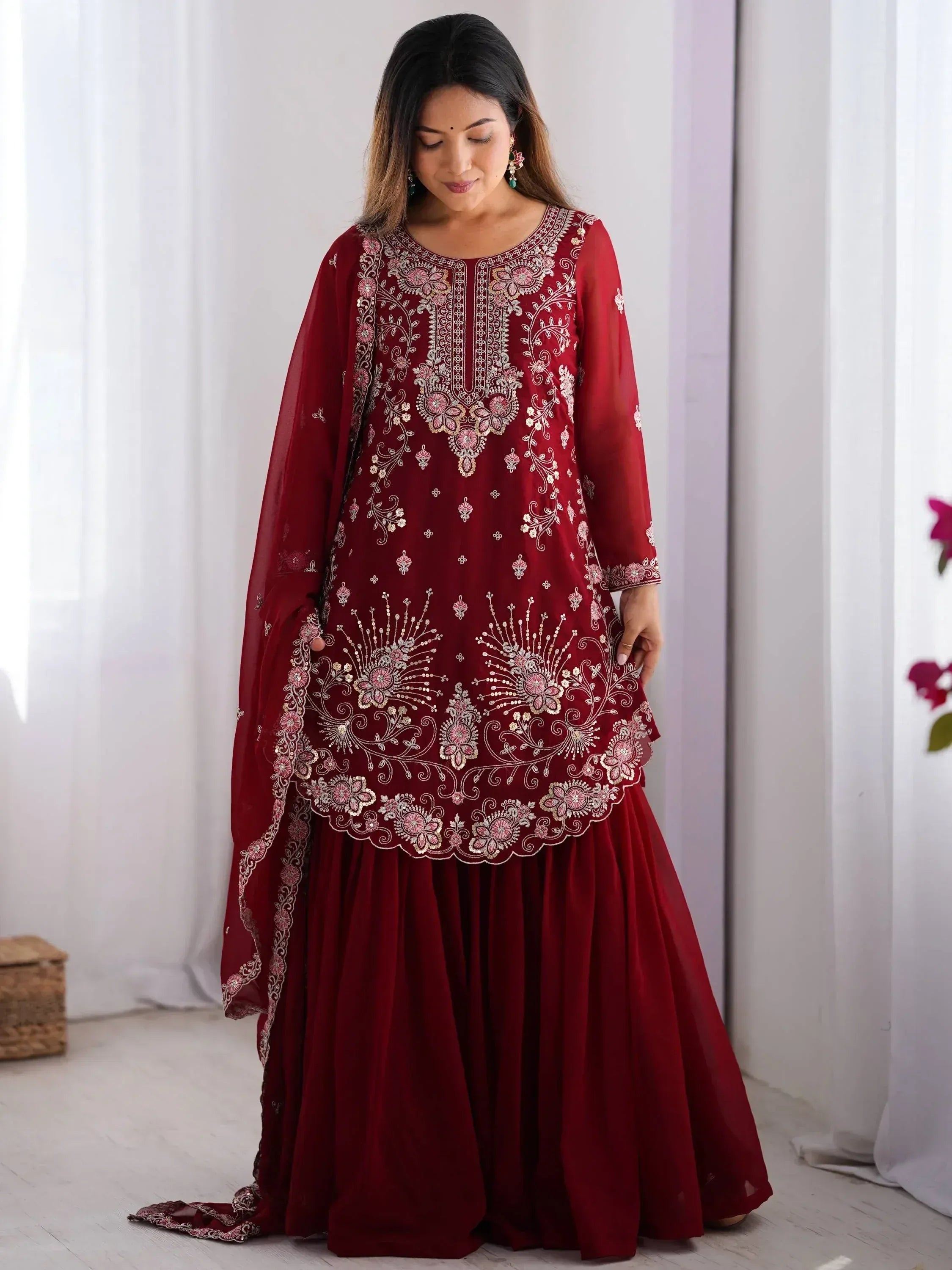 Maroon embroidered ethnic gown with floral detailing, perfect for Indian occasions and festive wear.