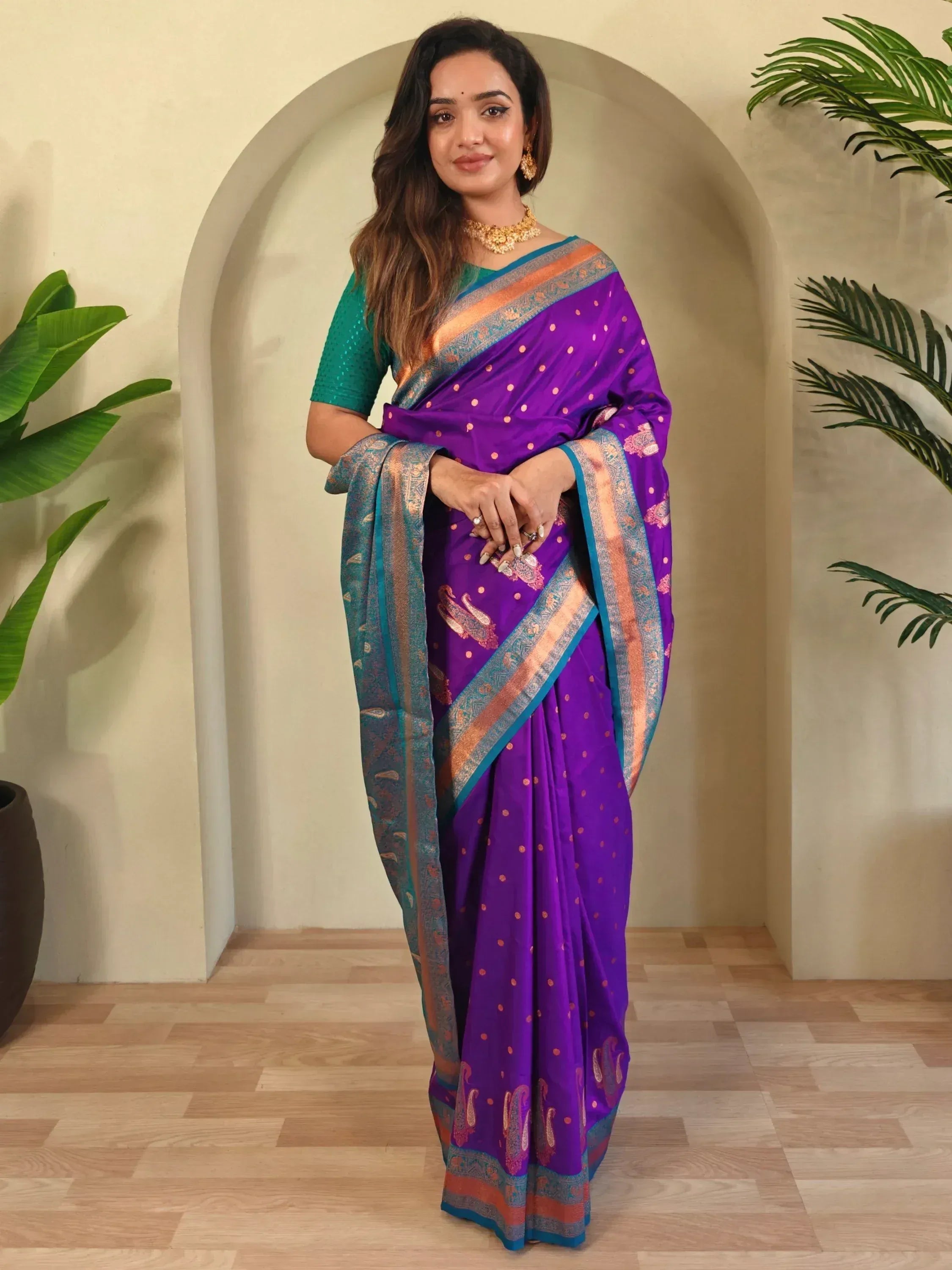 Purple saree with gold paisley print and teal border, paired with green blouse, ideal for Indian ethnic wear.
