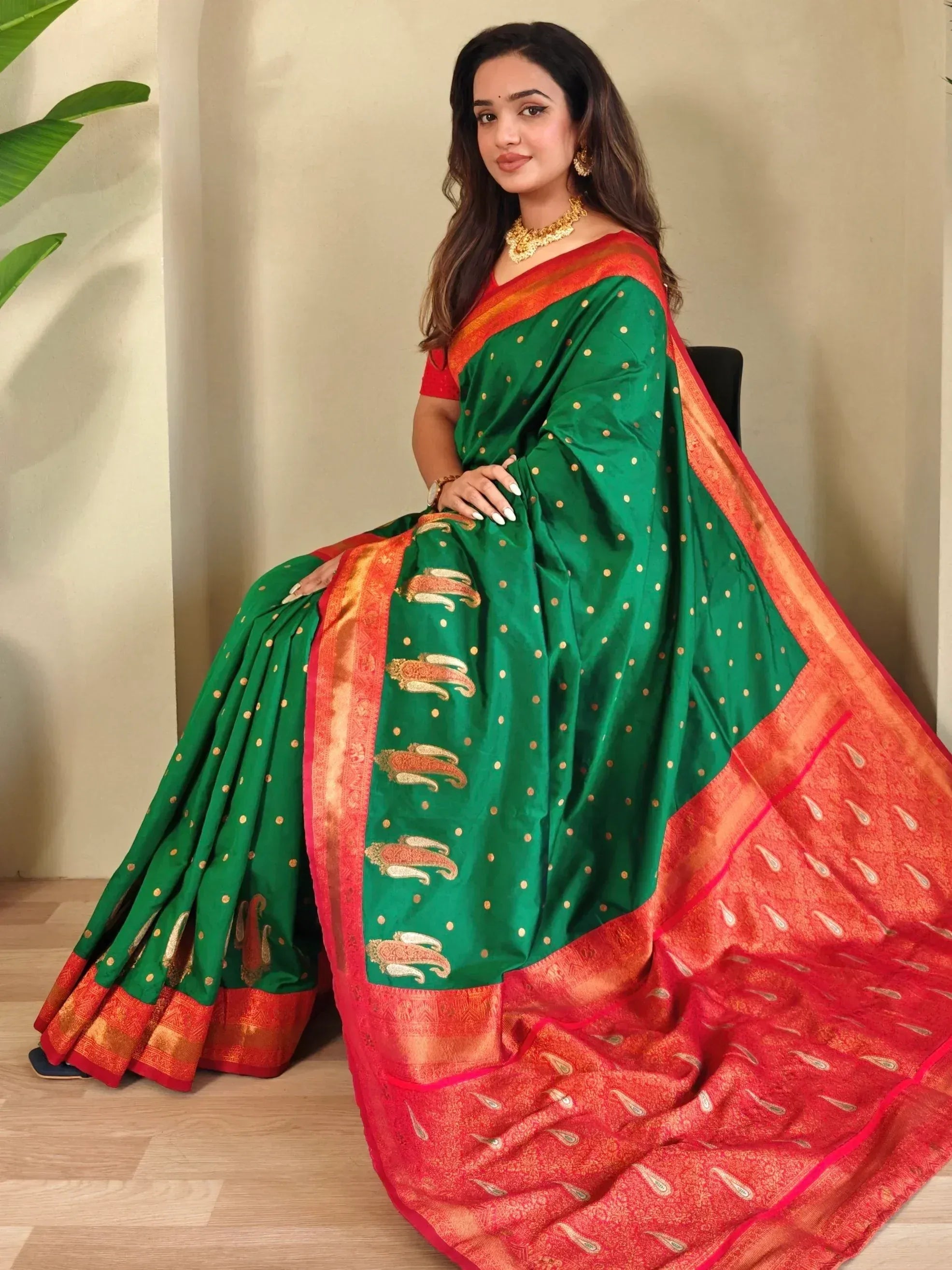 Green and red ethnic saree with gold dot and paisley print, perfect for Indian occasions