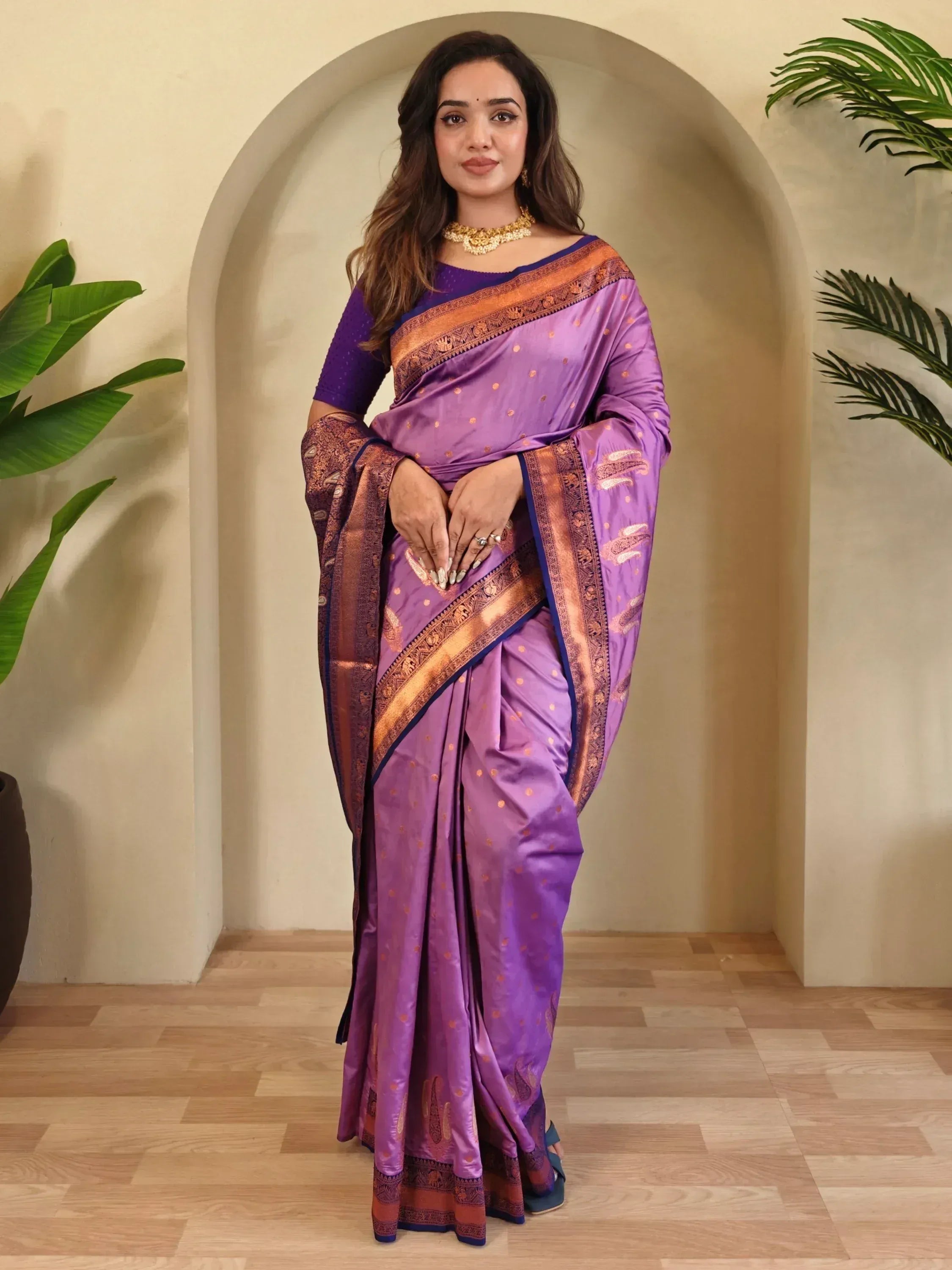 Woman in purple silk saree with gold border and blouse, Indian ethnic wear for festive occasions