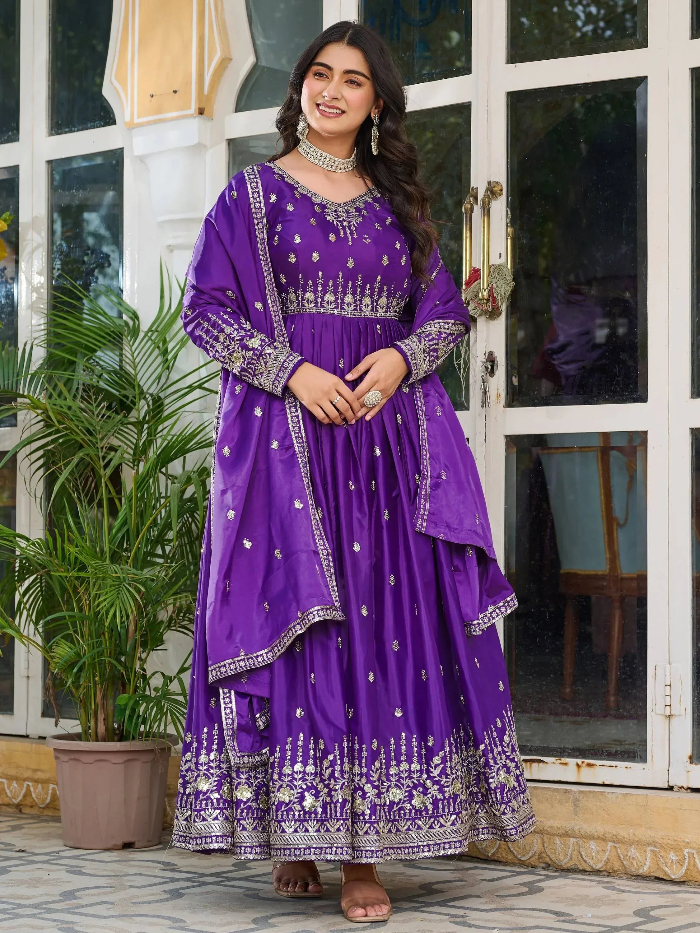 Woman in a purple embroidered Anarkali suit with dupatta, traditional Indian ethnic wear