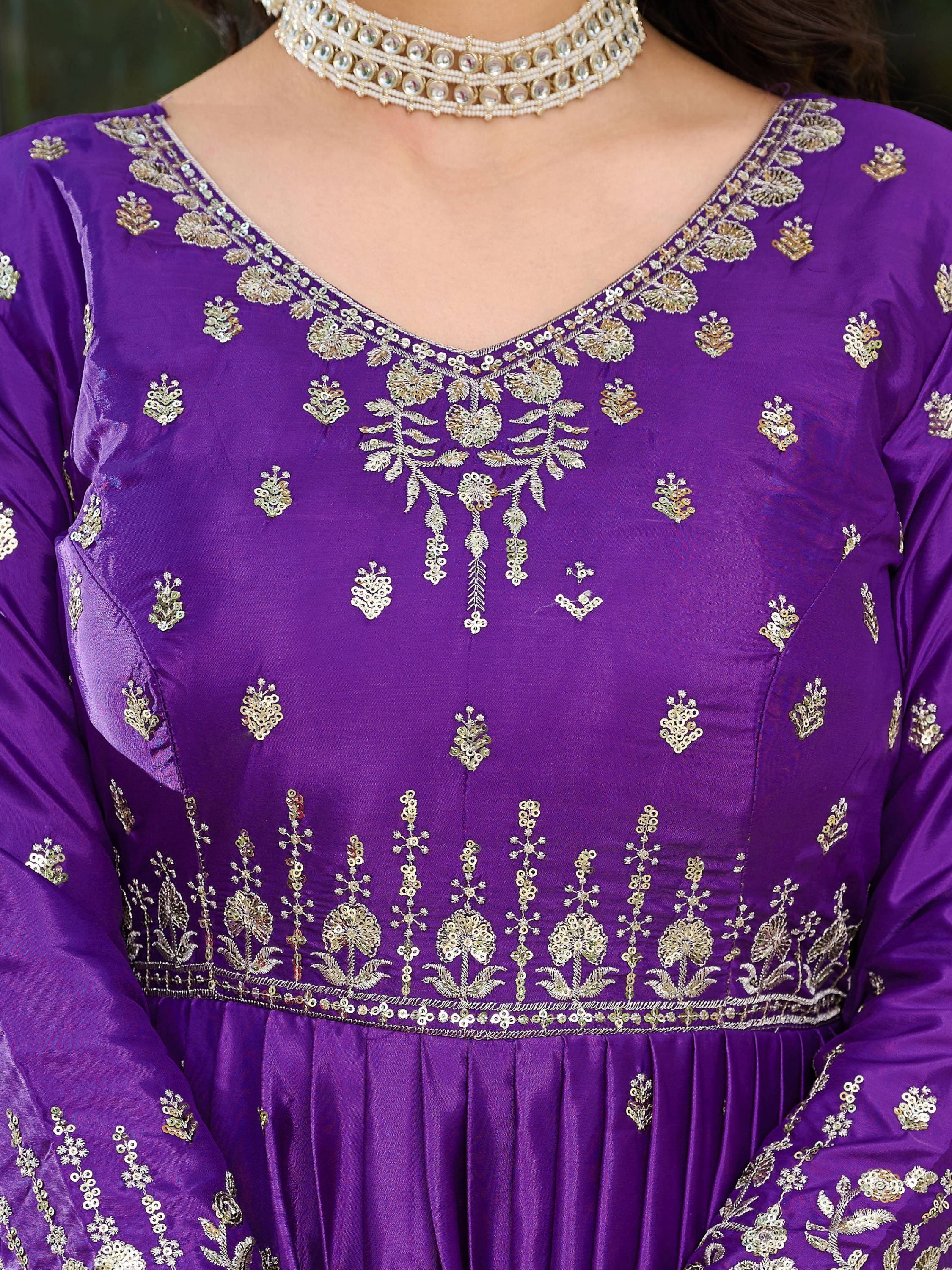 Purple Indian ethnic gown with gold embroidery and pearl choker necklace