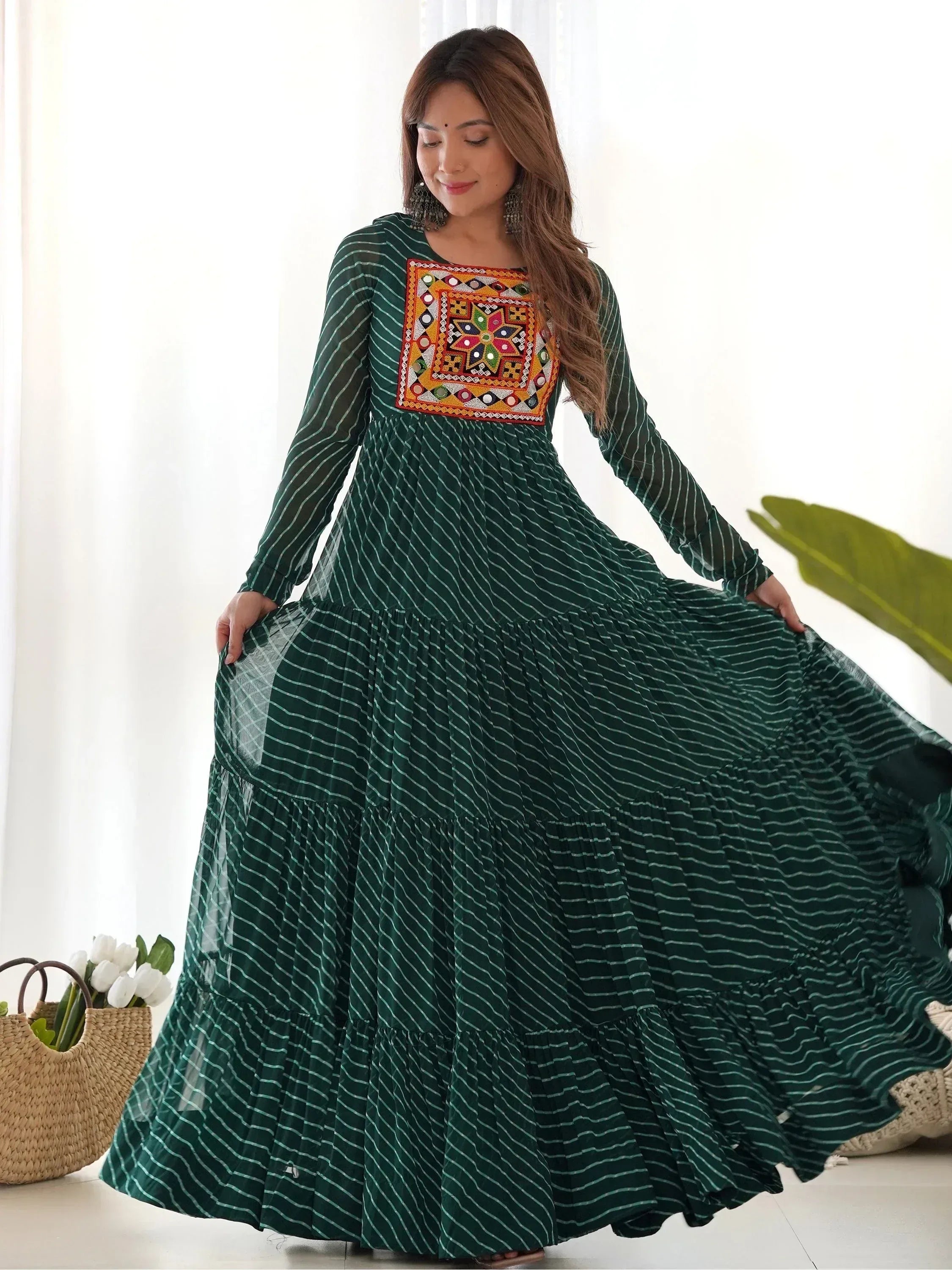 Green striped ethnic gown with colorful mirror work, long sleeves, tiered skirt, perfect for Indian occasions.