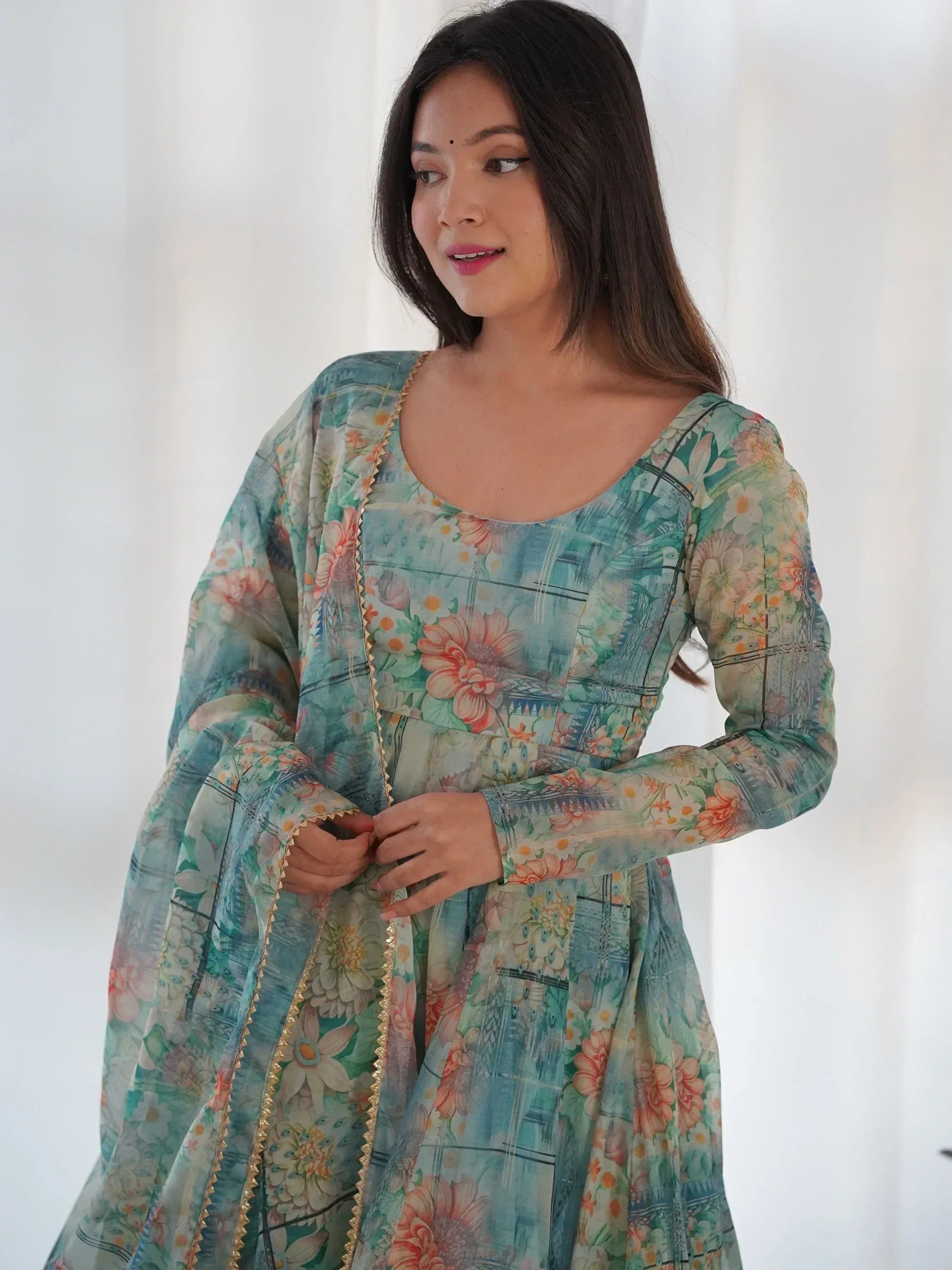 Floral printed ethnic gown with gold trim, perfect for Indian occasions and festive wear.