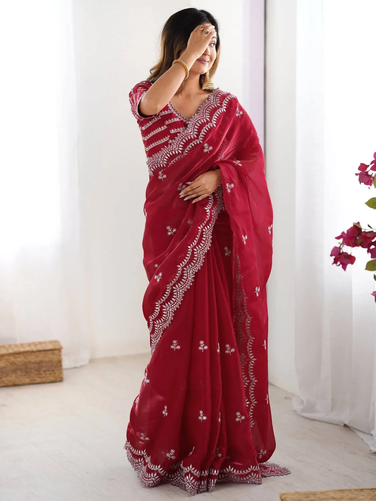 Woman in maroon embroidered saree with white floral detailing, perfect for Indian ethnic occasions