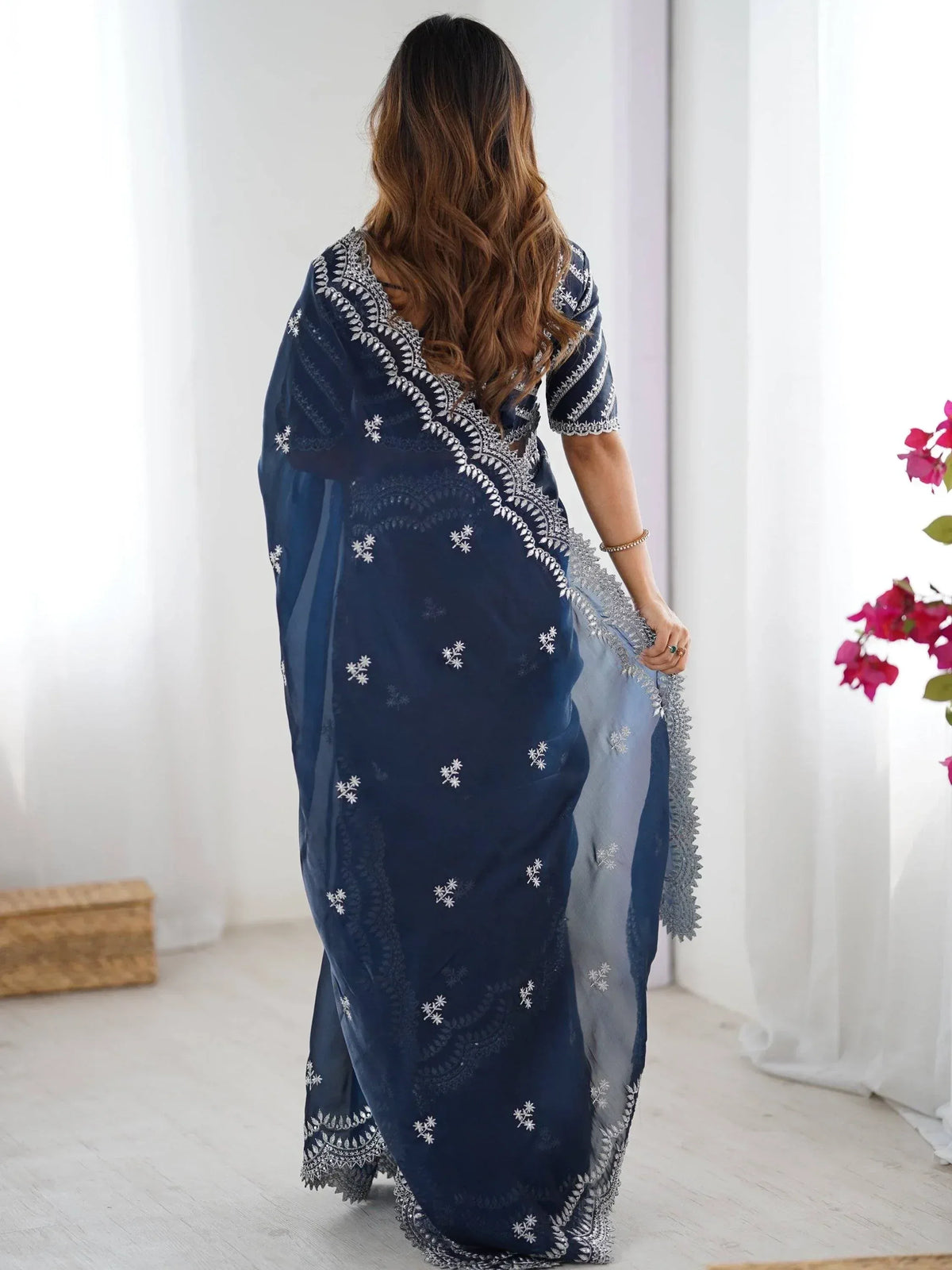 Navy blue embroidered saree with white floral motifs, elegant Indian ethnic wear for women