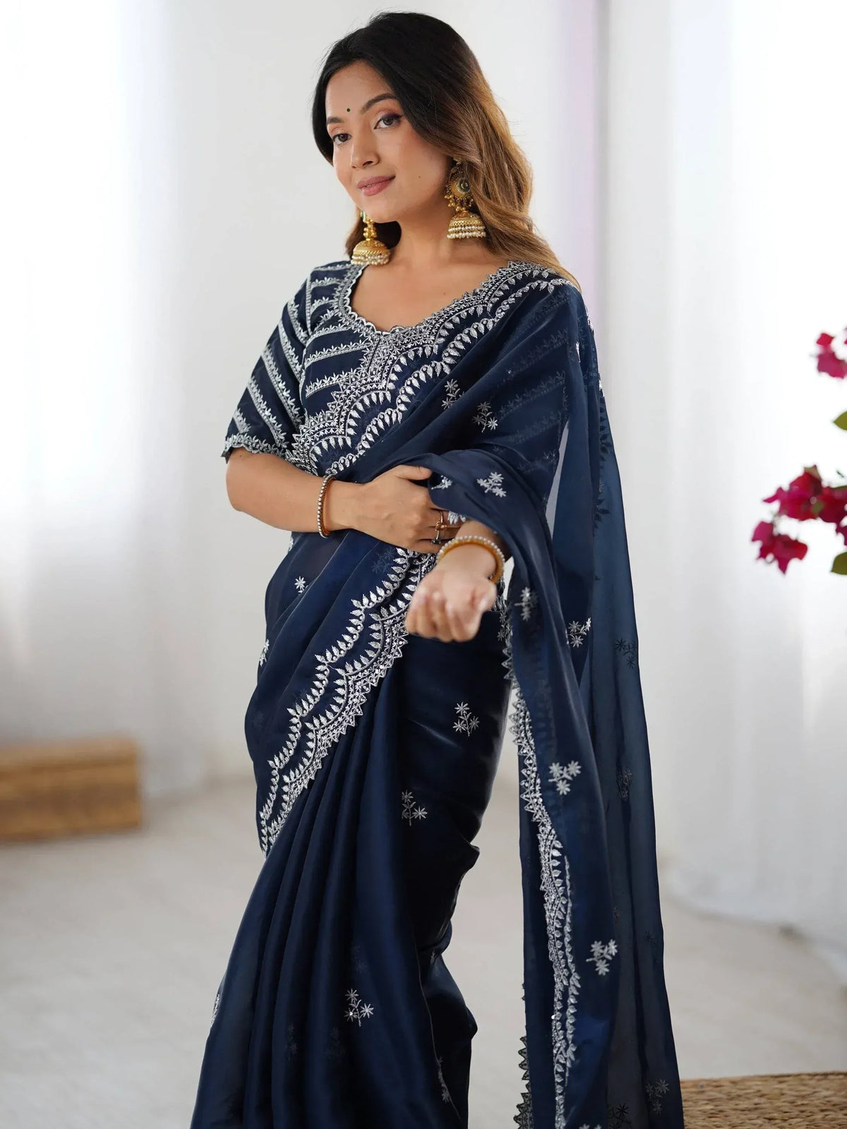 Navy blue embroidered saree with white floral motifs, perfect for Indian ethnic wear occasions