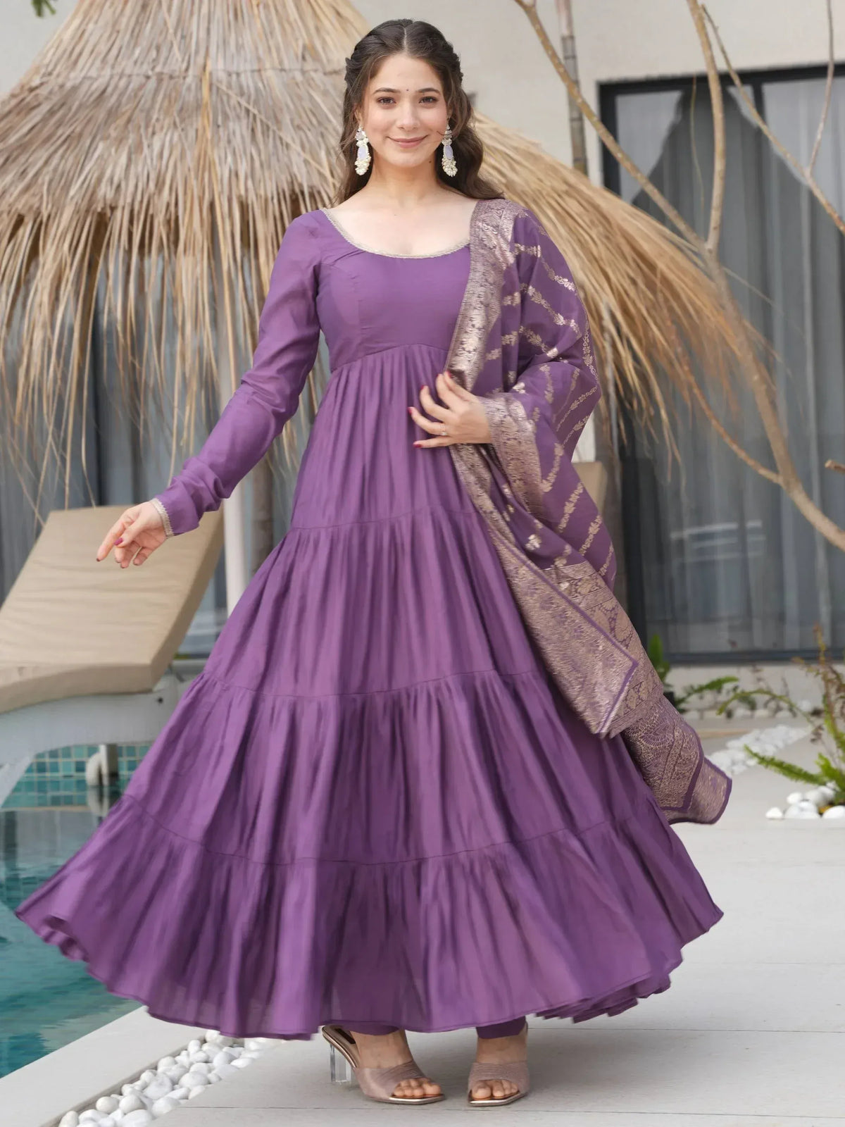 Purple tiered ethnic gown with gold embroidered dupatta, perfect for Indian festive occasions