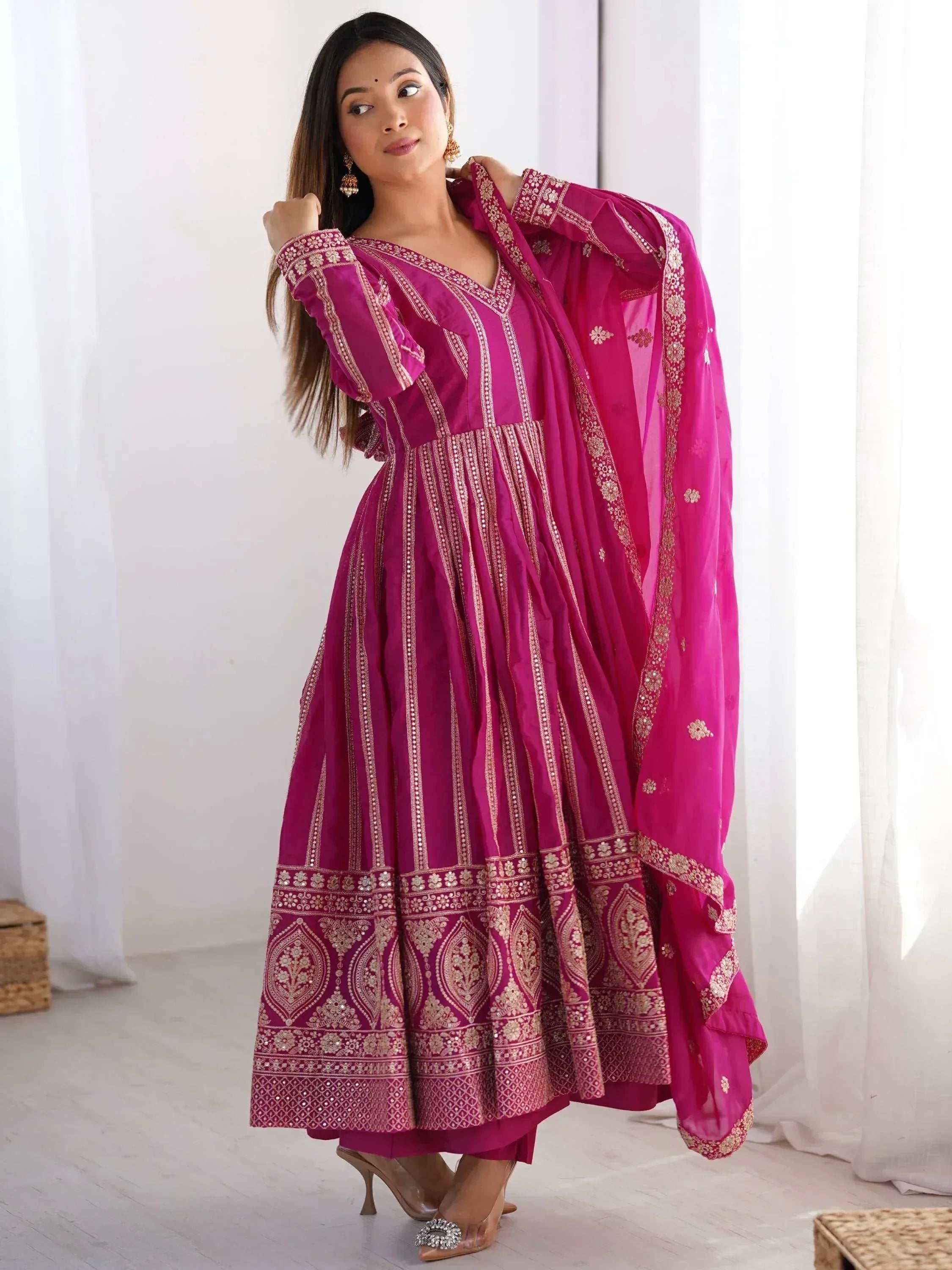 Fuchsia ethnic anarkali suit with gold embroidery and dupatta, perfect for Indian occasions