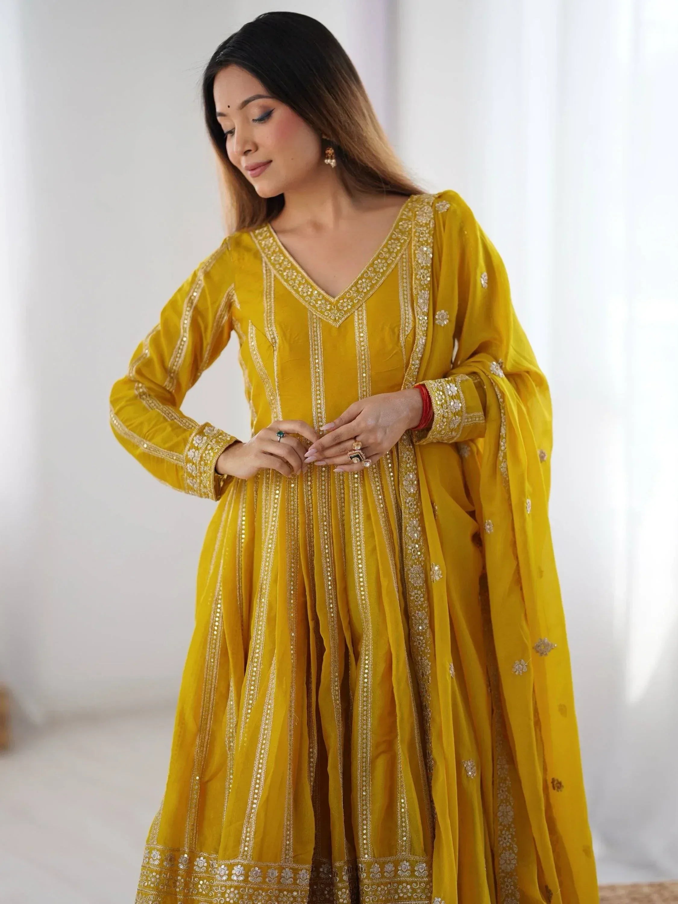 Yellow embroidered salwar kameez with gold detailing, perfect for Indian ethnic wear occasions