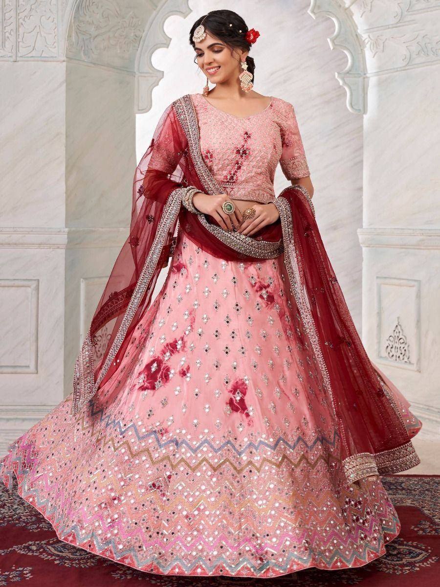 Pink designer lehenga choli with floral embroidery and maroon dupatta, perfect for Indian weddings