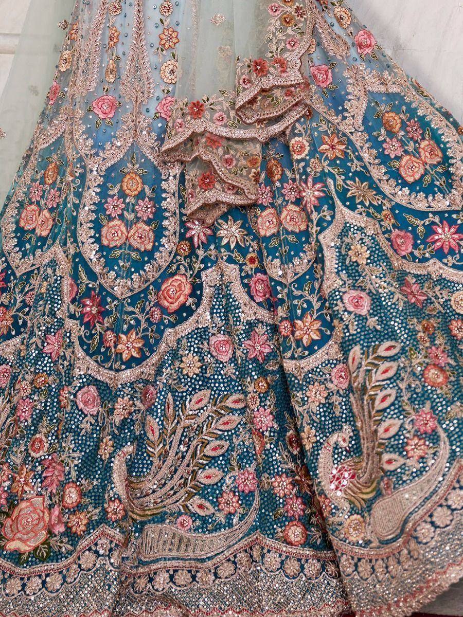 Blue designer lehenga with floral and peacock embroidery, perfect for Indian weddings and ethnic events