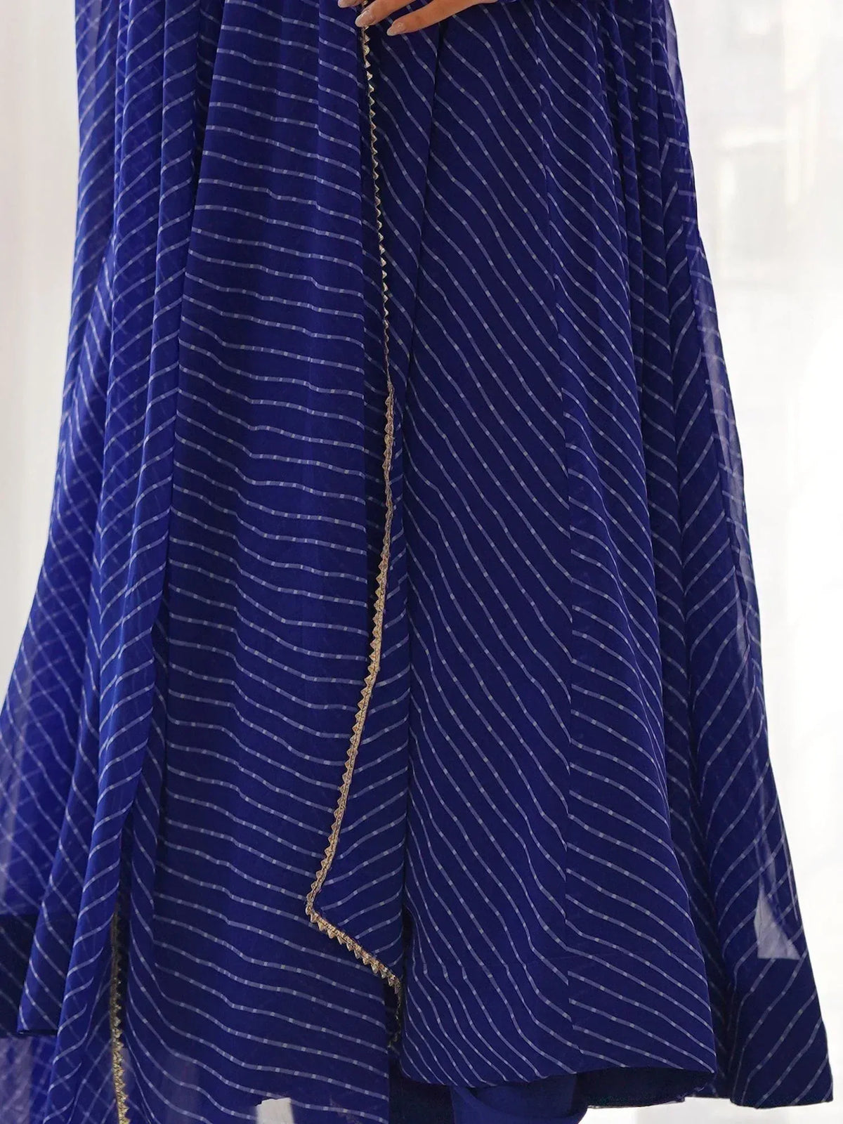 Royal blue striped ethnic gown with gold trim, perfect for Indian occasions and festive wear.