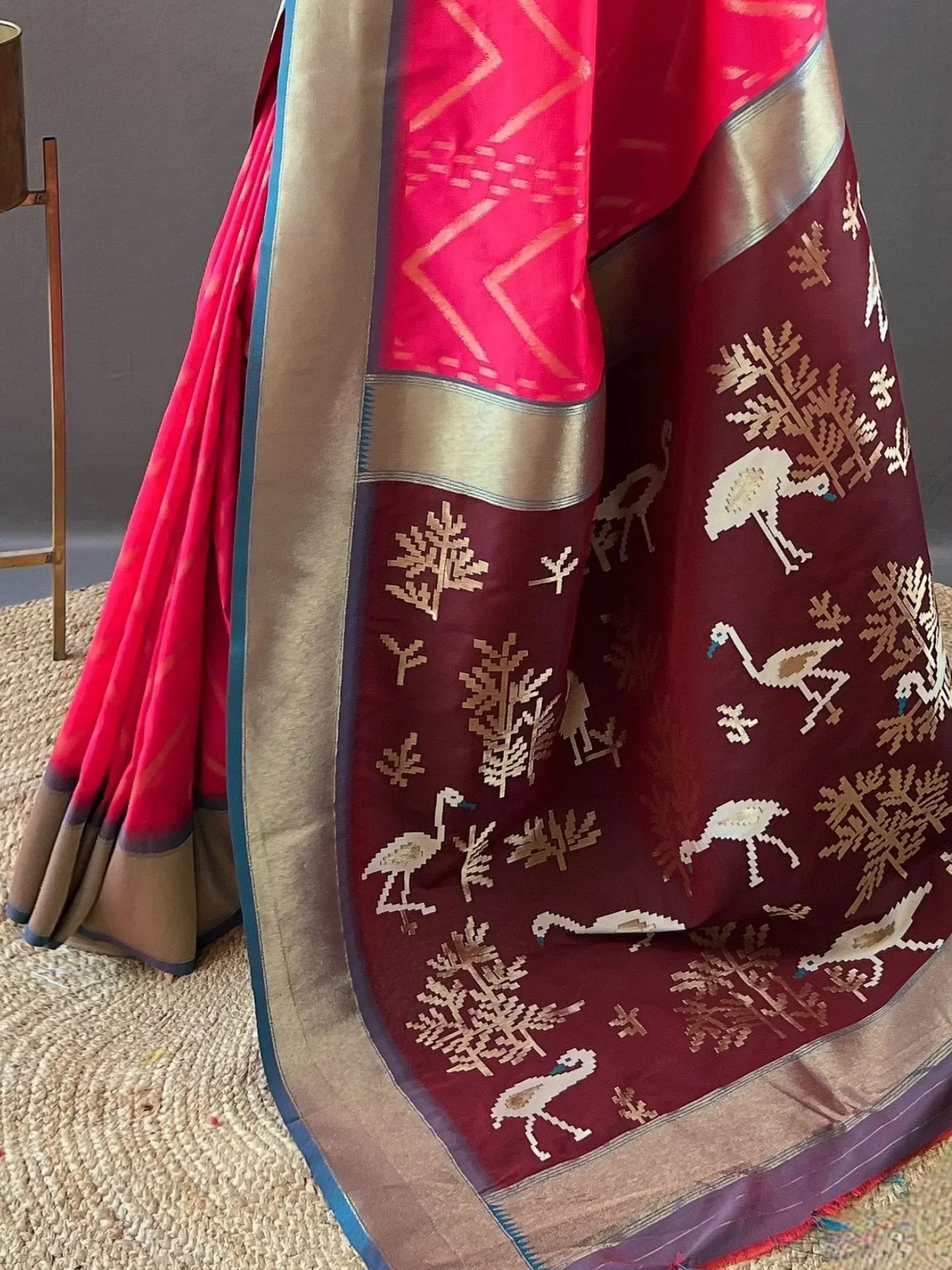 Vibrant pink and maroon ethnic saree with bird and tree motifs, gold border, designer Indian wear