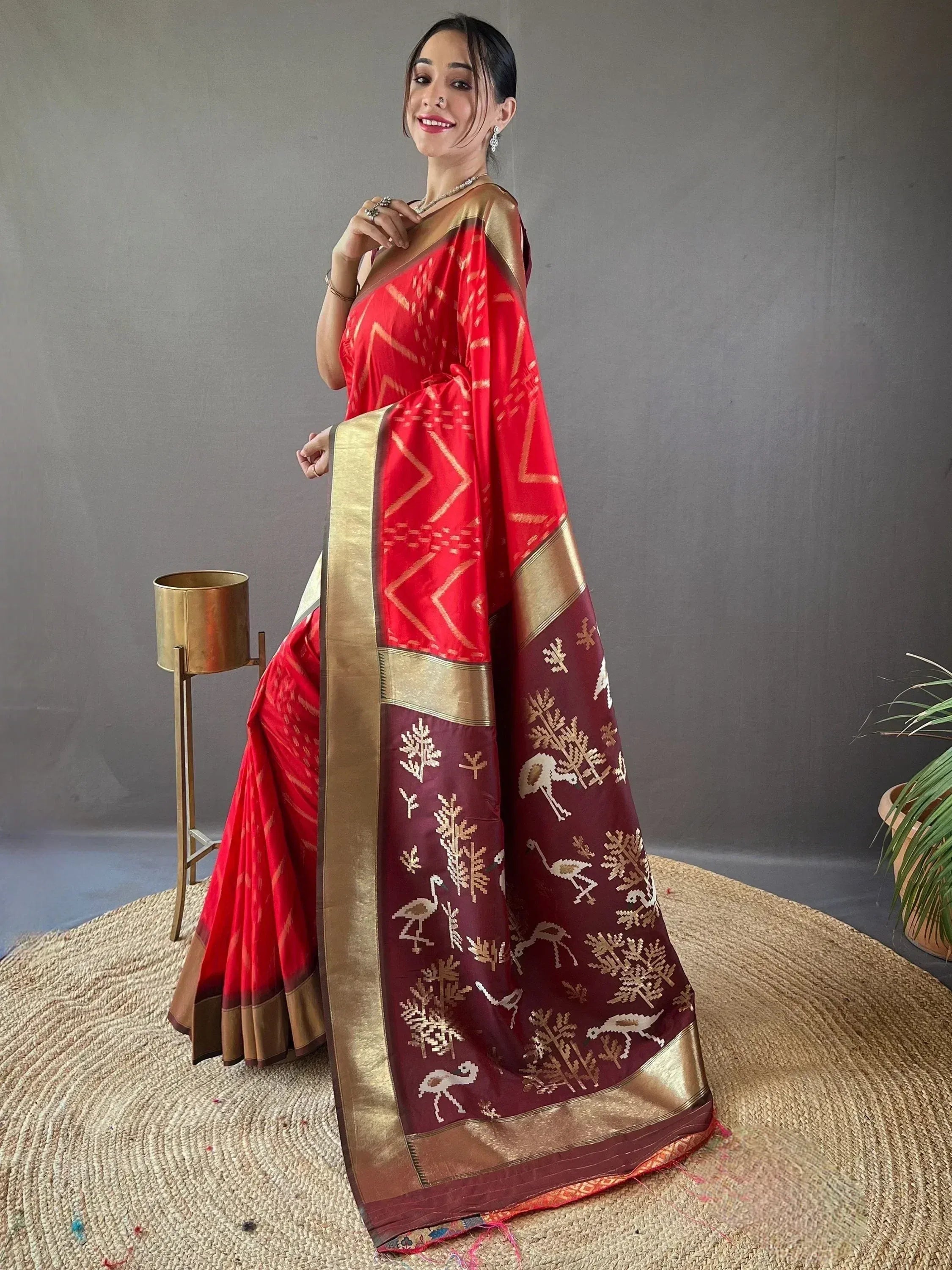 Red and maroon ethnic saree with gold geometric and bird motifs, perfect for Indian occasions