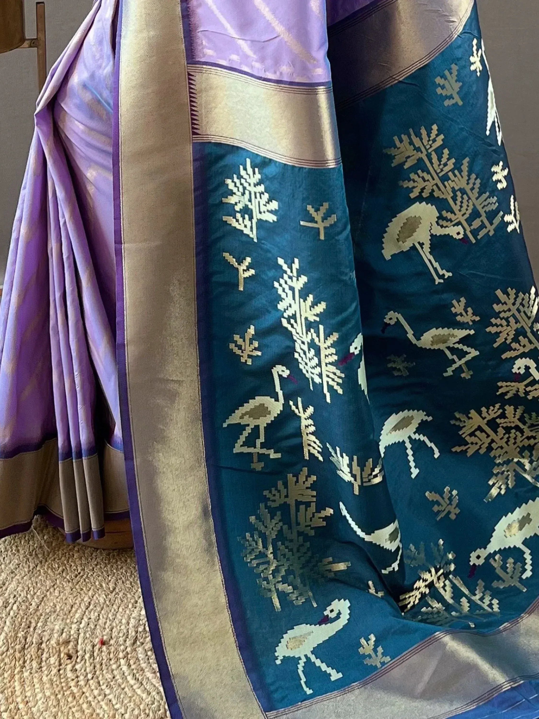 Purple and teal designer saree with bird and tree motifs, gold border, ethnic wear
