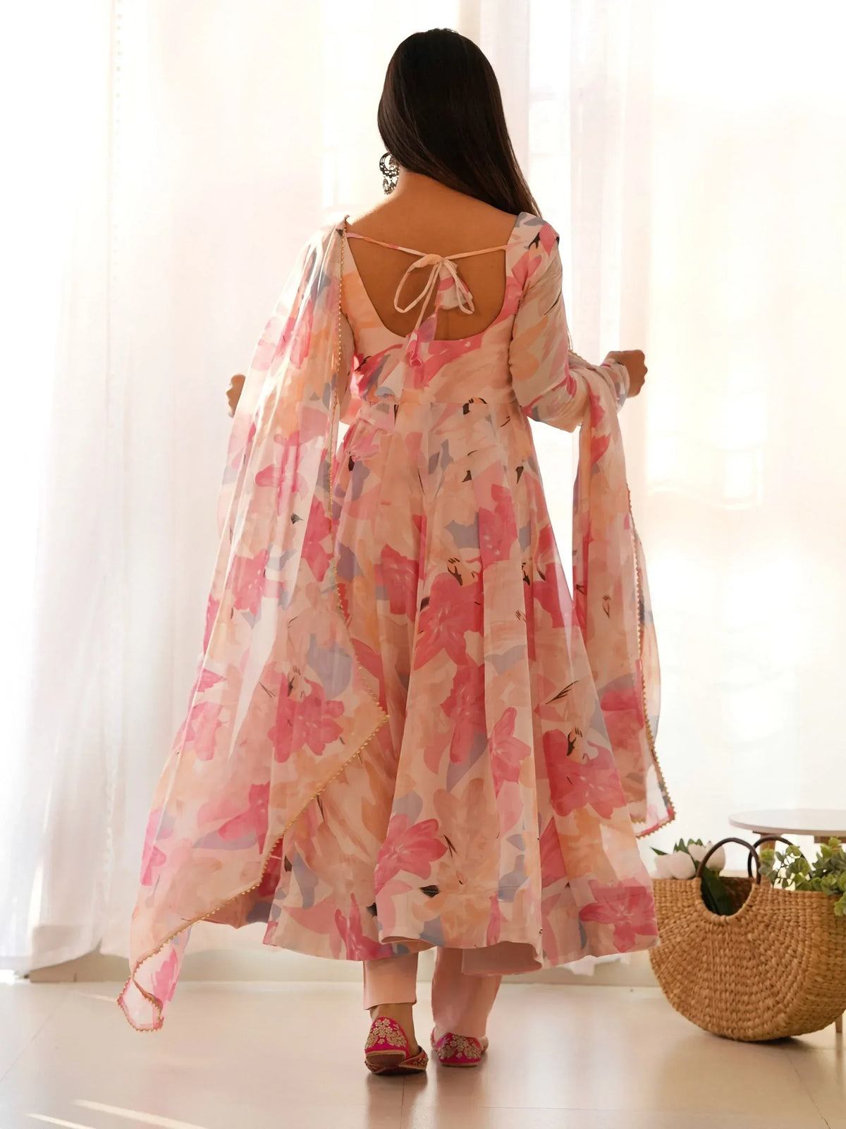Pink floral print anarkali suit with back tie detail, paired with dupatta and embroidered juttis