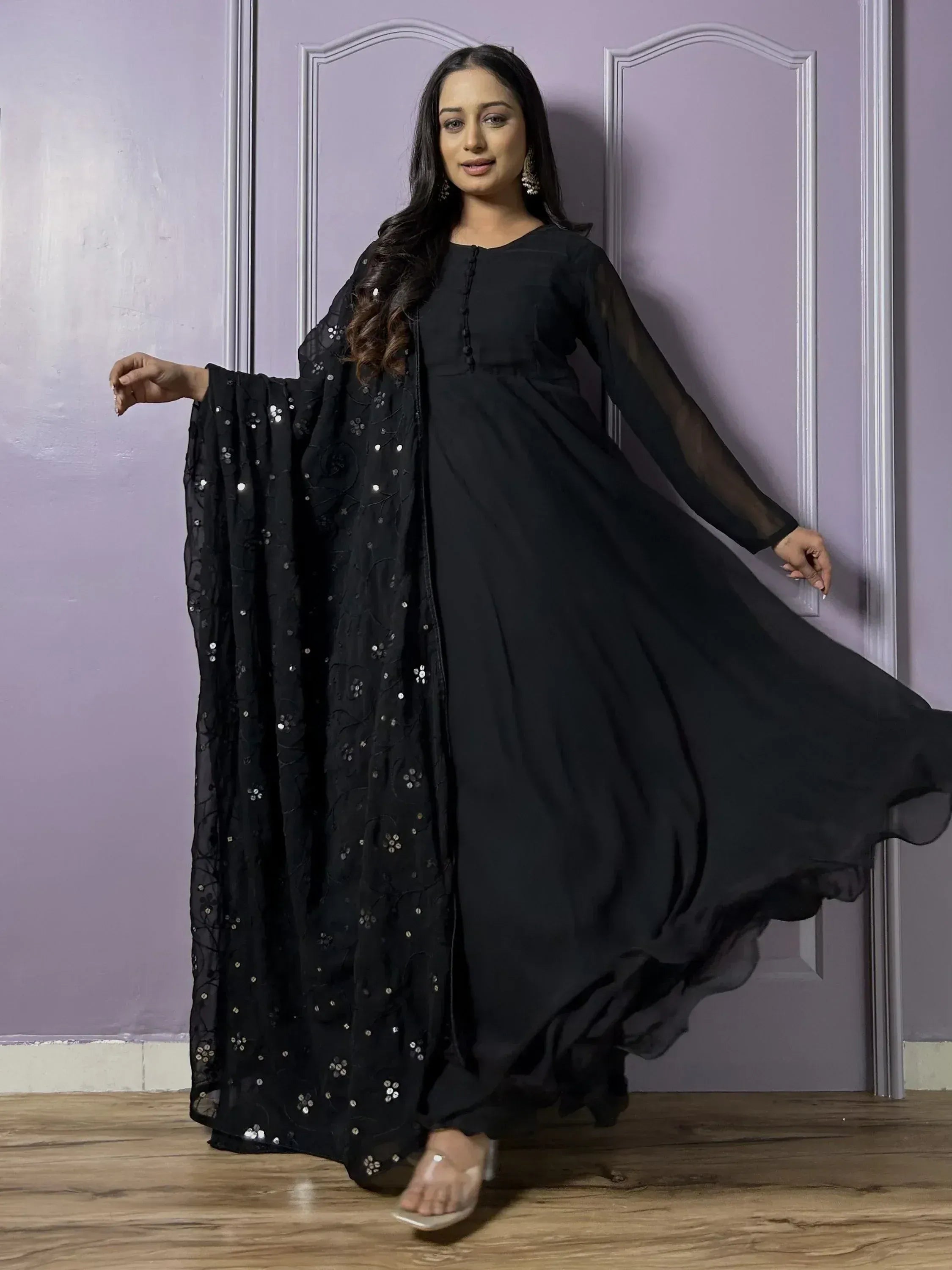 Woman wearing elegant black ethnic gown with sequin dupatta, Indian festive wear