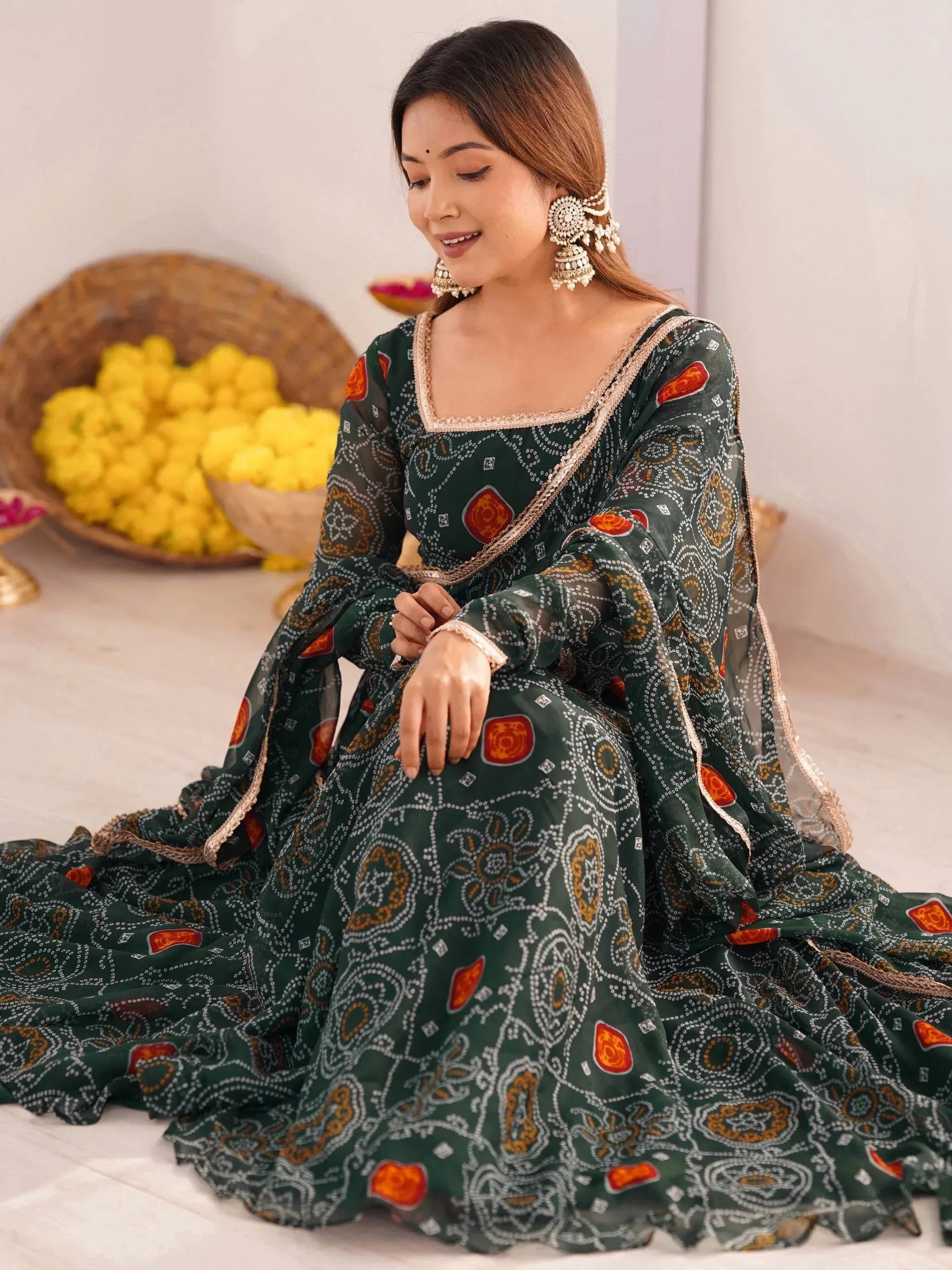 Woman in green printed ethnic gown with gold embroidery, traditional Indian wear for festive occasions
