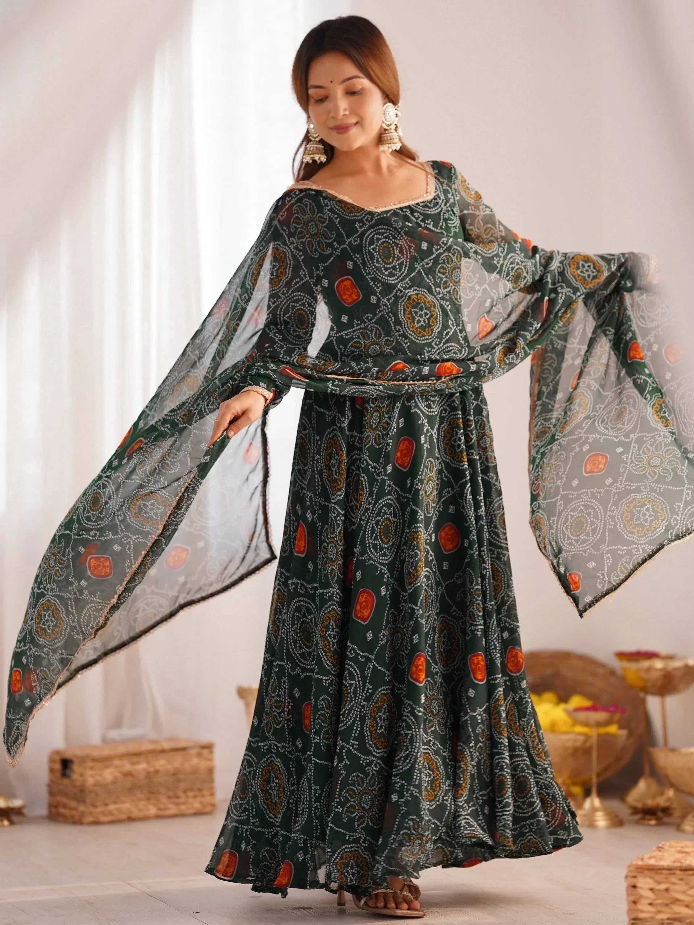 Elegant green printed ethnic gown with flared sleeves and traditional motifs