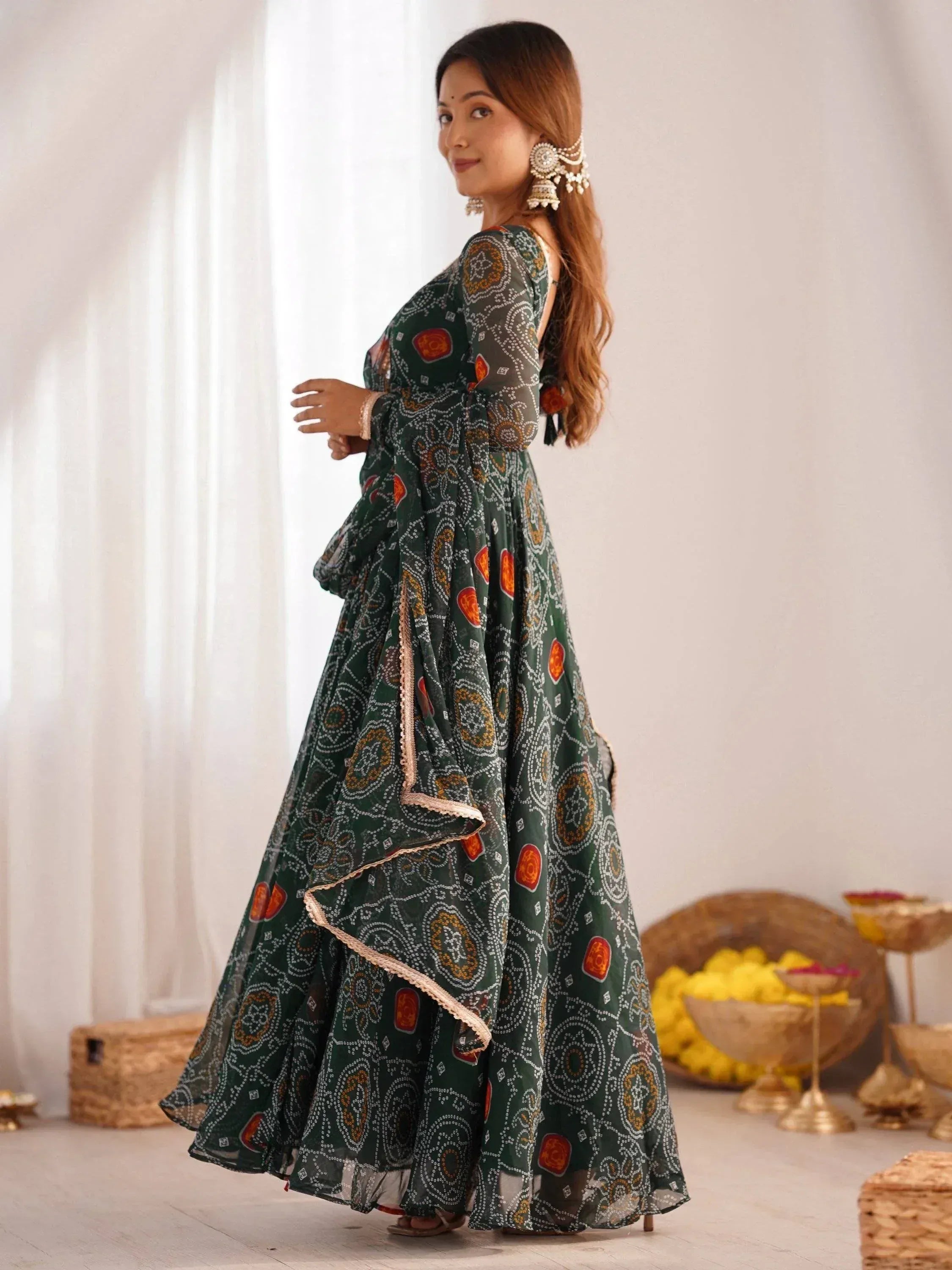 Woman in green printed ethnic gown with ruffled hem, perfect for Indian festive occasions