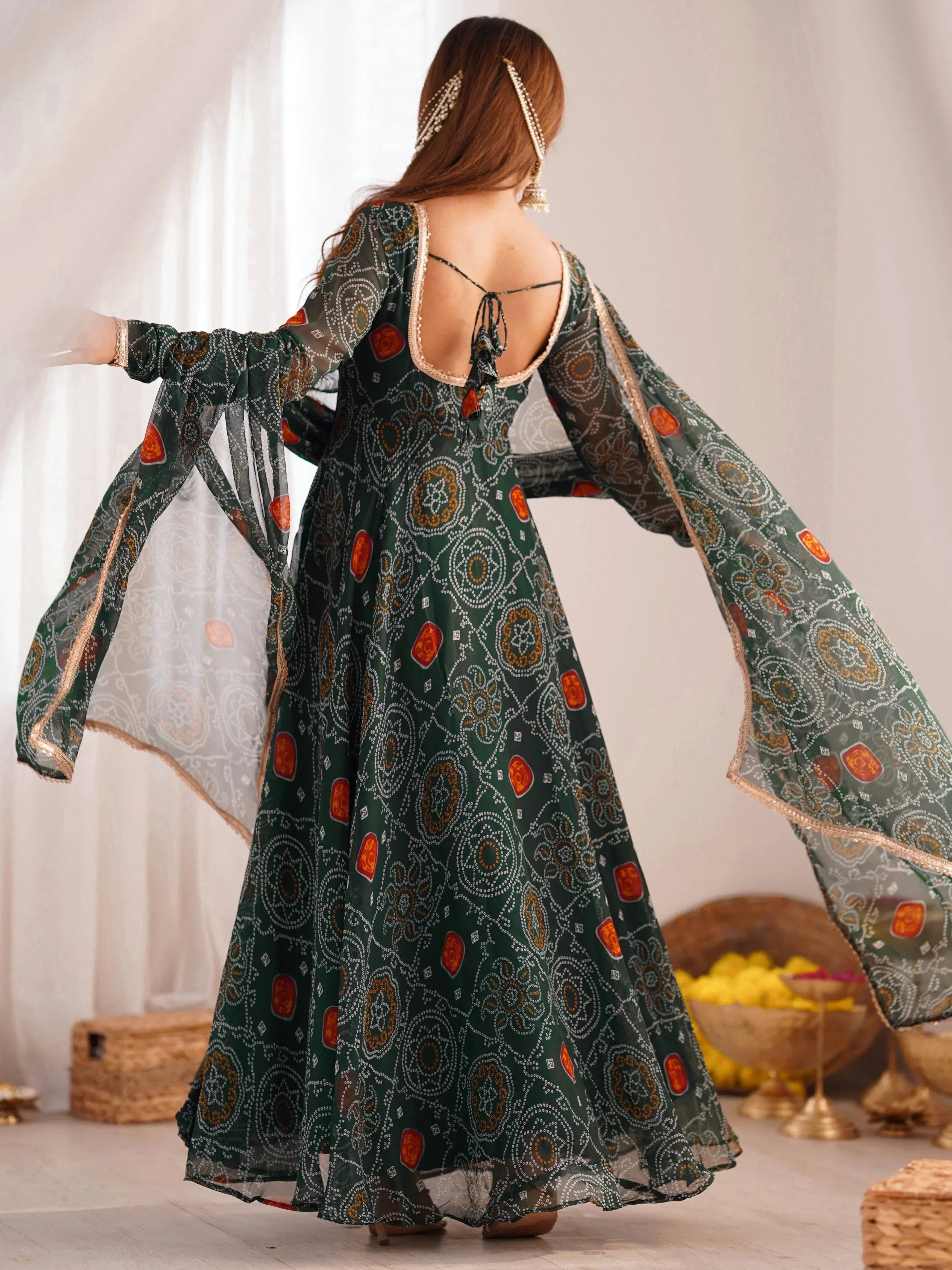 Green printed ethnic gown with flared sleeves and back tie, perfect for Indian occasions