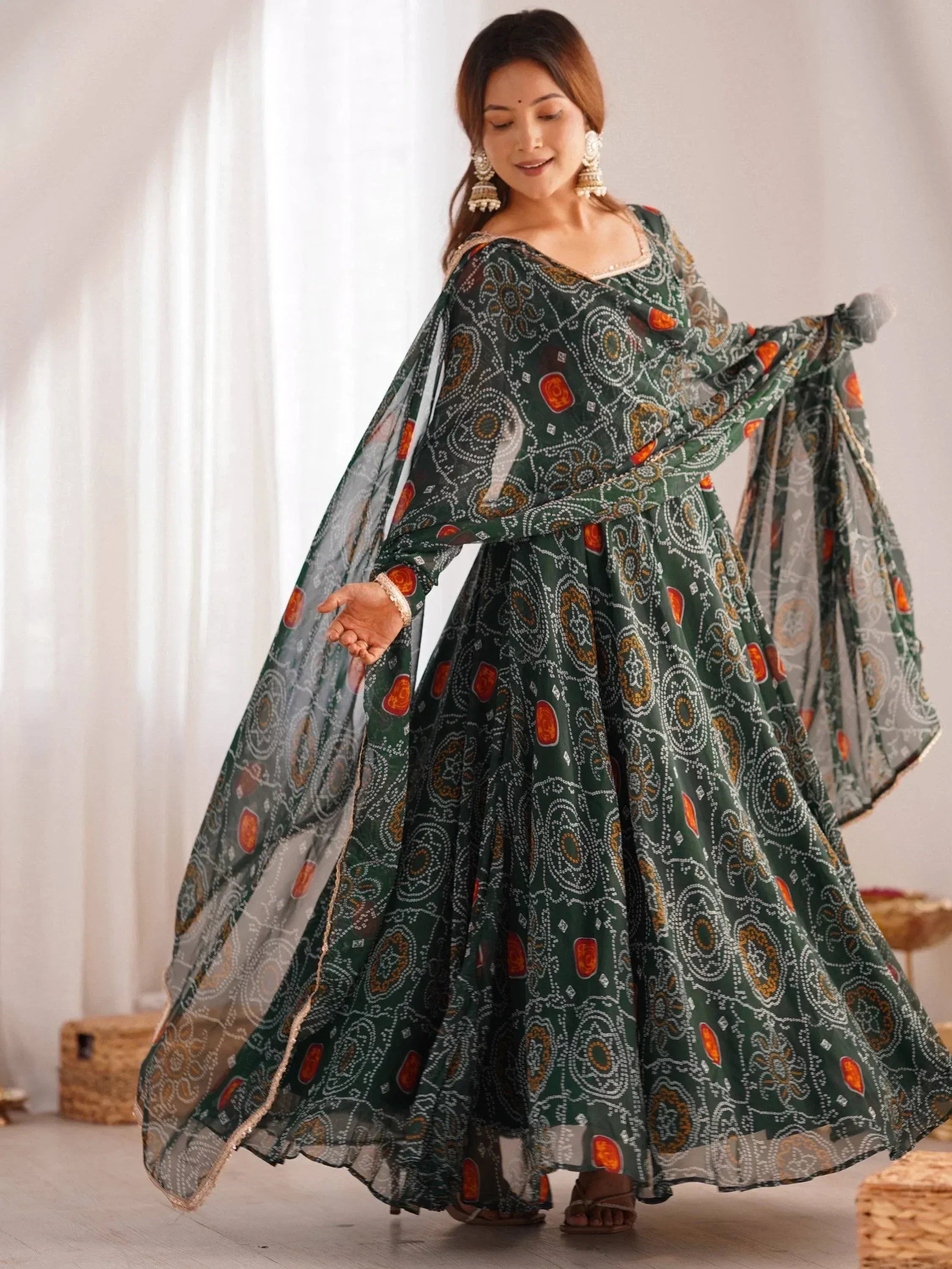 Green printed ethnic gown with flared sleeves and intricate patterns for festive occasions