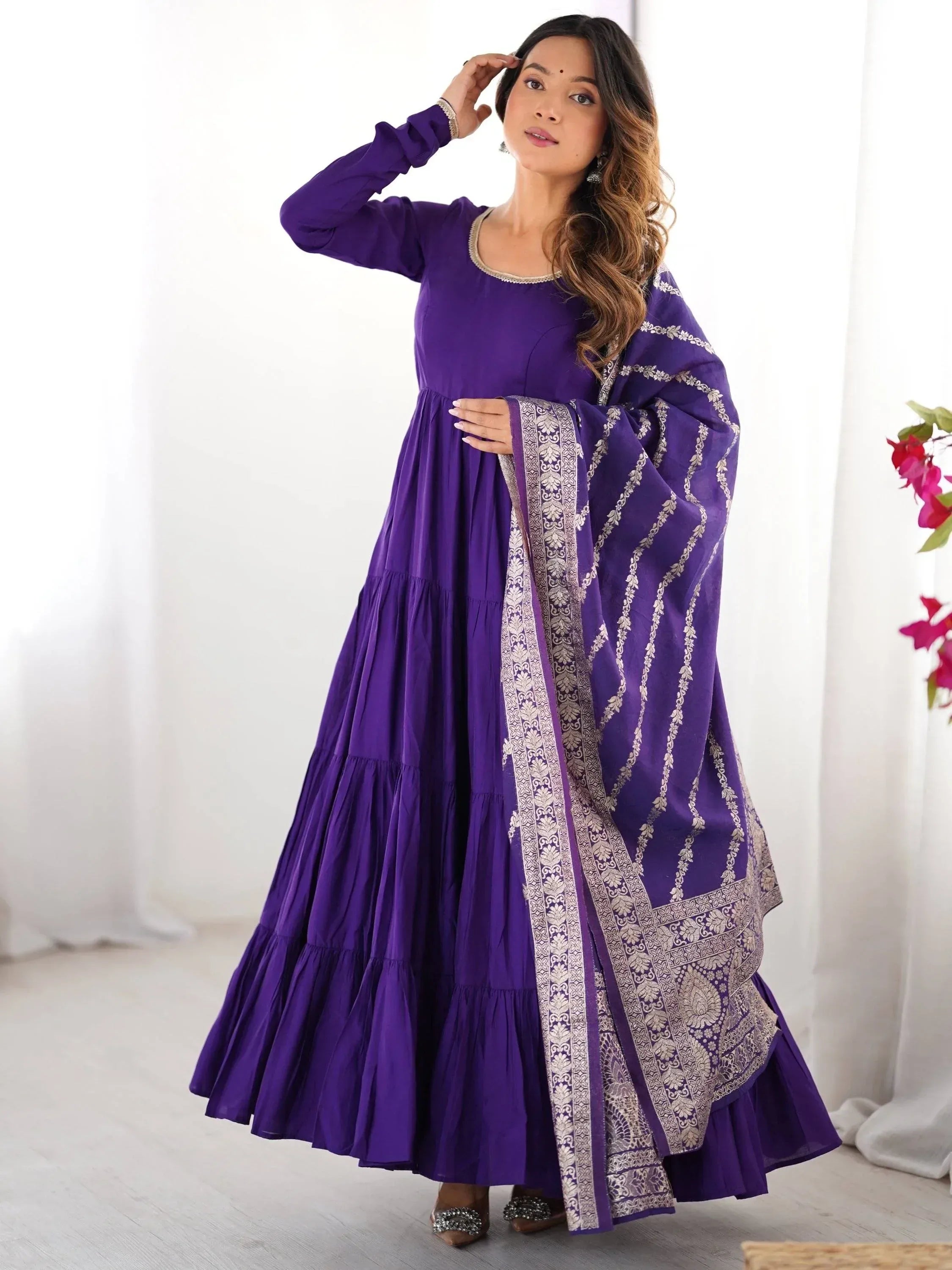 Purple tiered ethnic gown with gold embroidery, perfect for Indian festive occasions