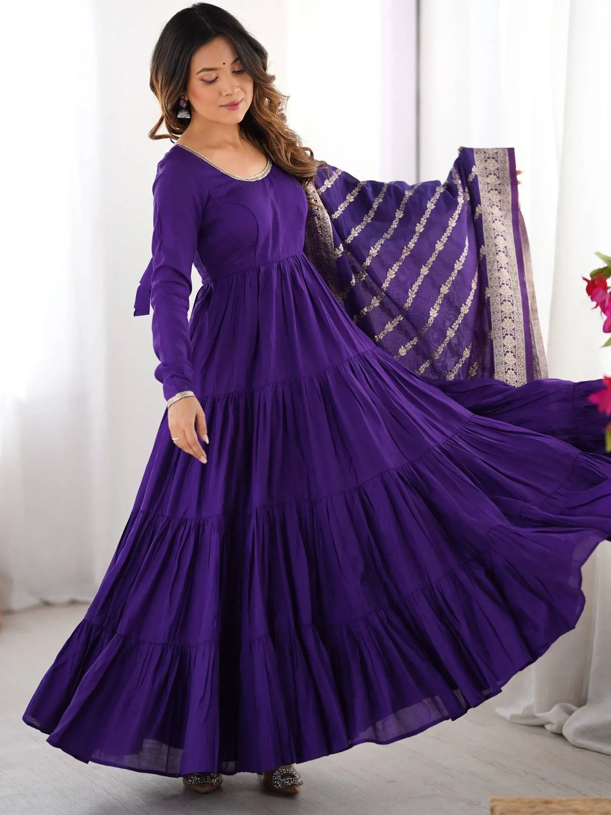 Purple tiered ethnic gown with gold embroidery, perfect for Indian occasions and festive wear.