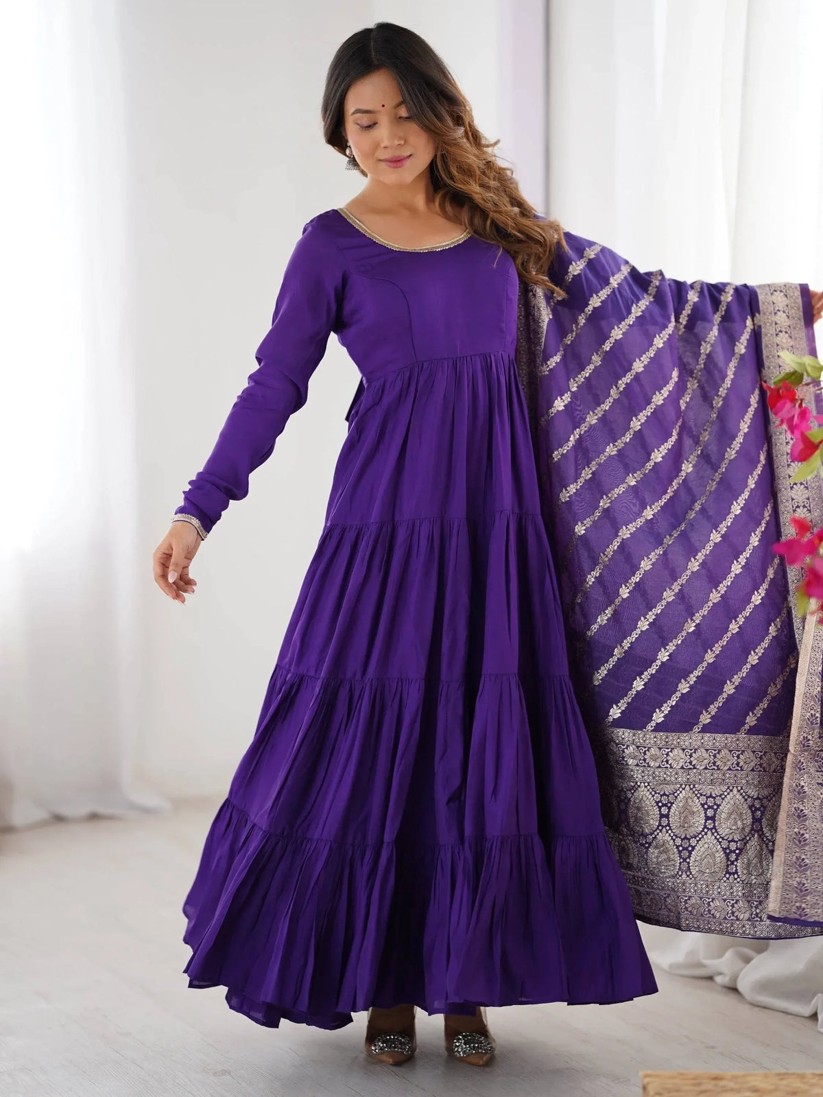 Purple tiered ethnic gown with matching embroidered dupatta, perfect for Indian occasions