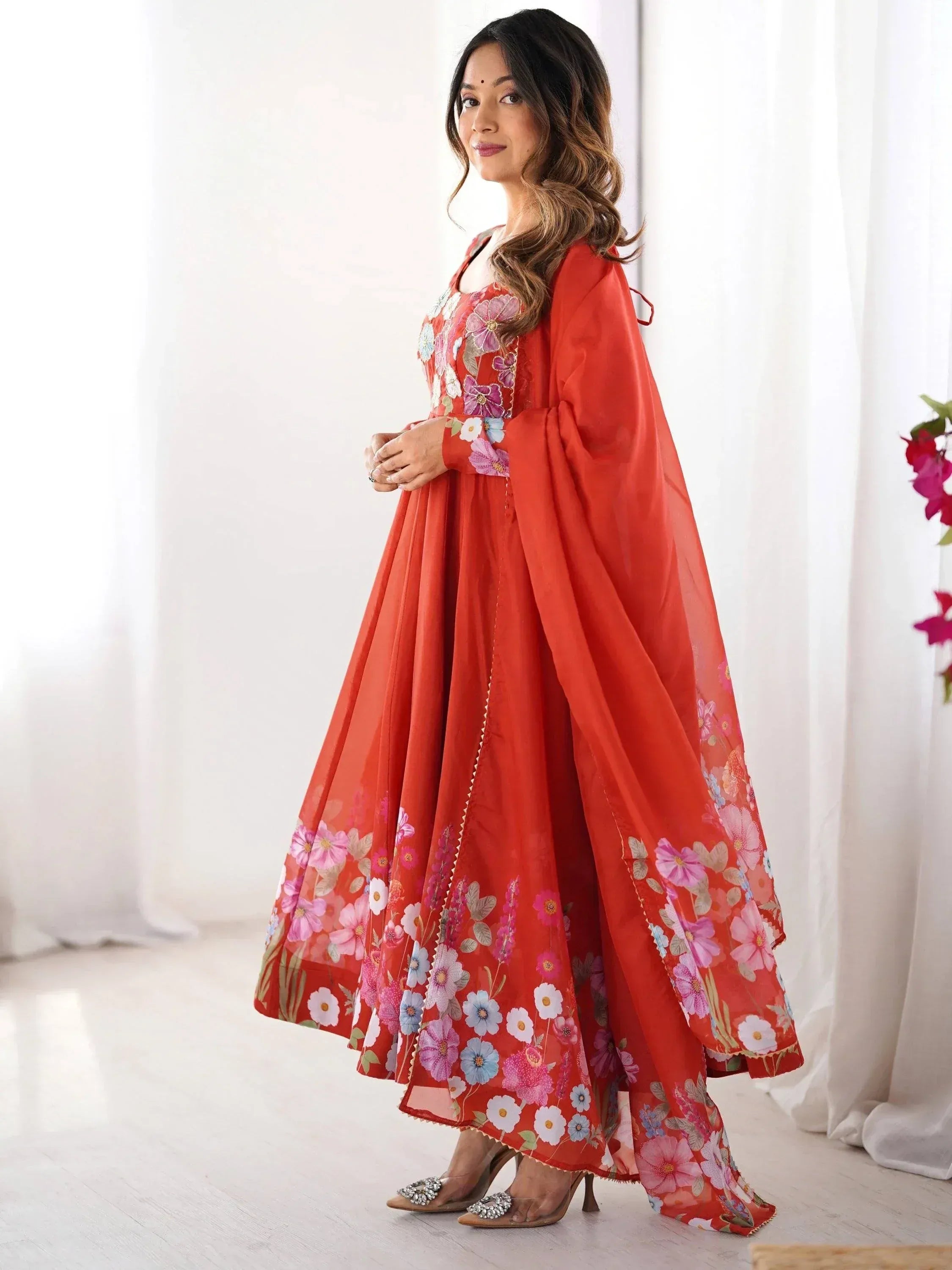 Red floral ethnic gown with cape sleeves, perfect for Indian occasions and festive wear.