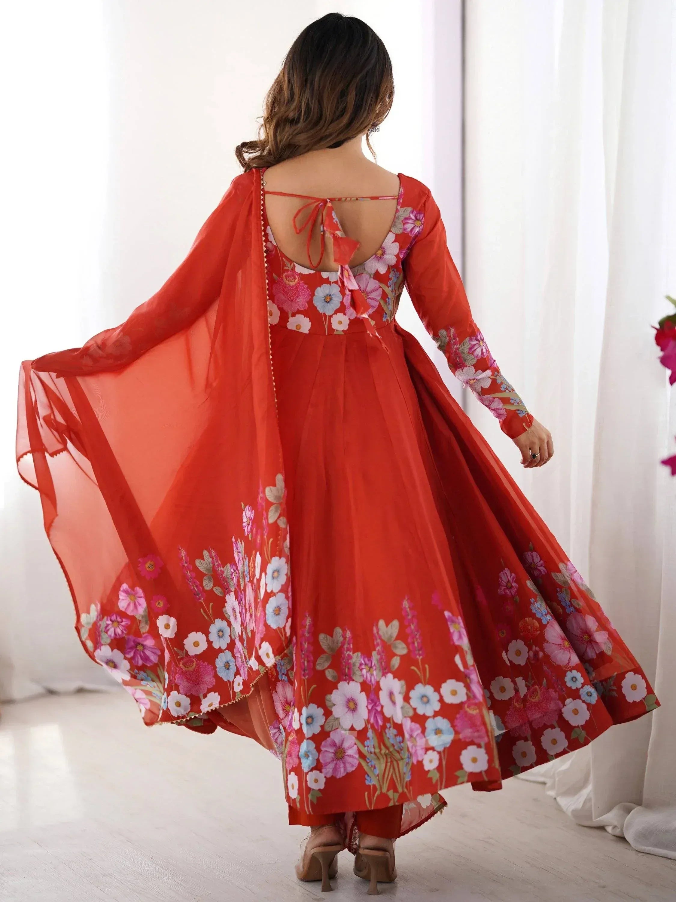 Red floral printed ethnic gown with back tie and sheer cape, perfect for Indian occasions