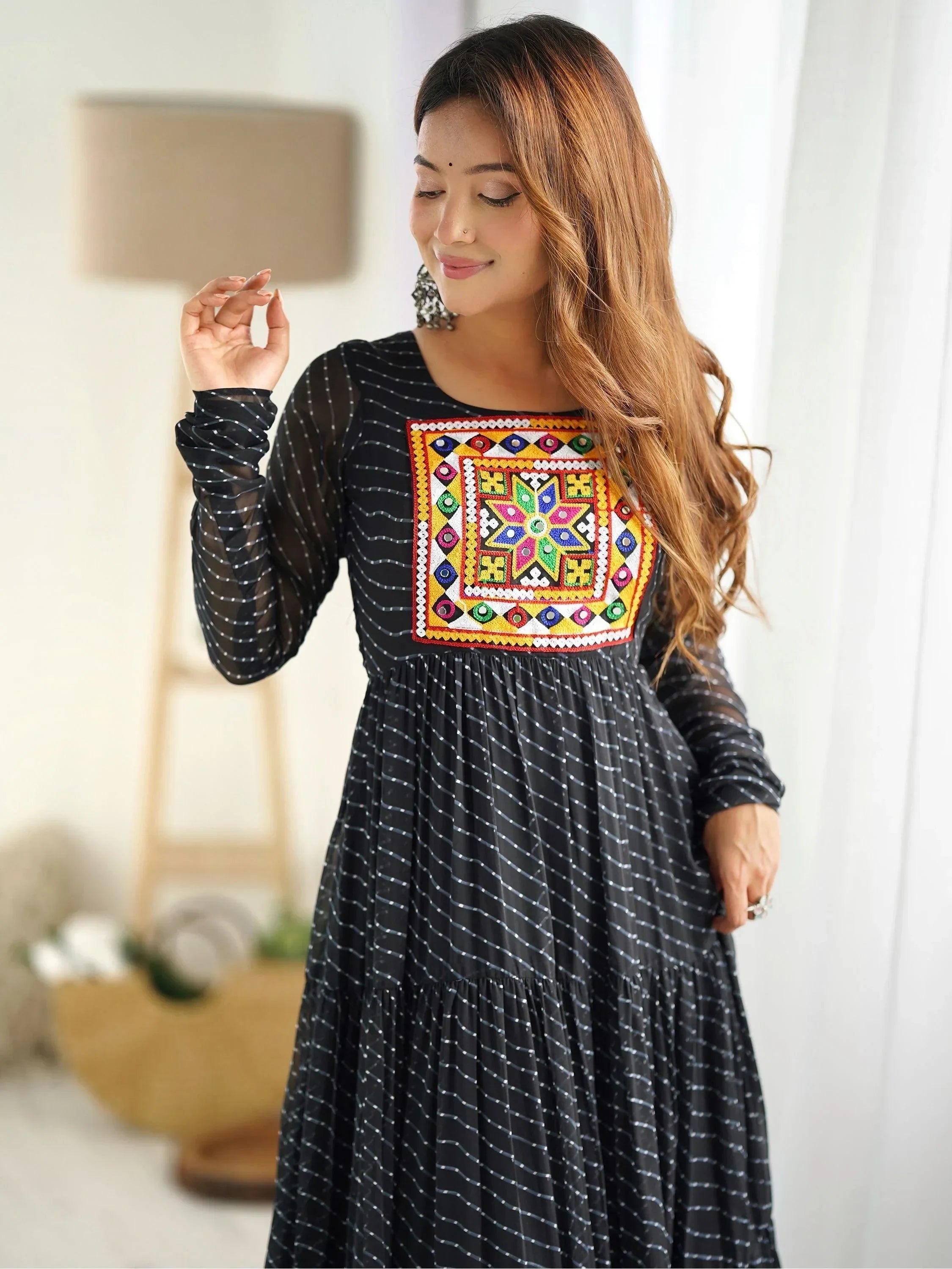Woman wearing black ethnic gown with colorful embroidered yoke and long sleeves
