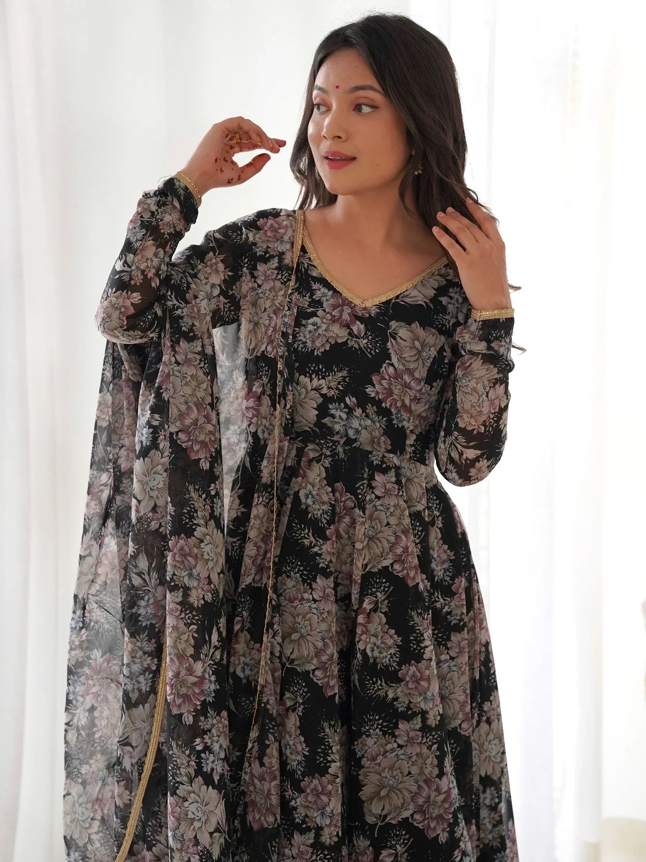 Black floral ethnic gown with gold trim, perfect for Indian occasions and festive wear