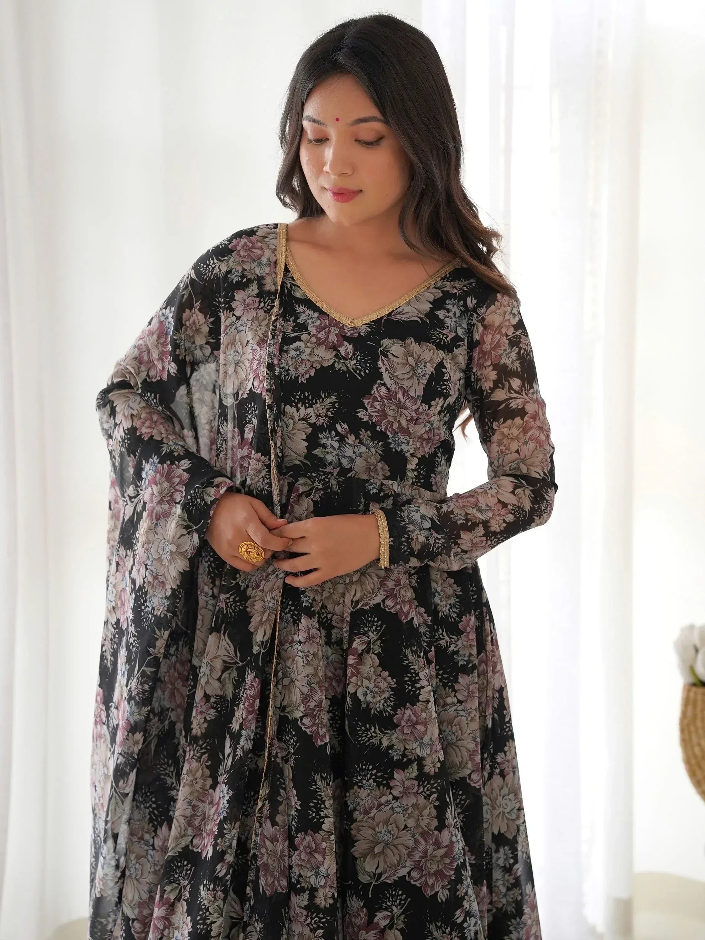 Black floral ethnic gown with gold trim, perfect for Indian occasions and festive wear.