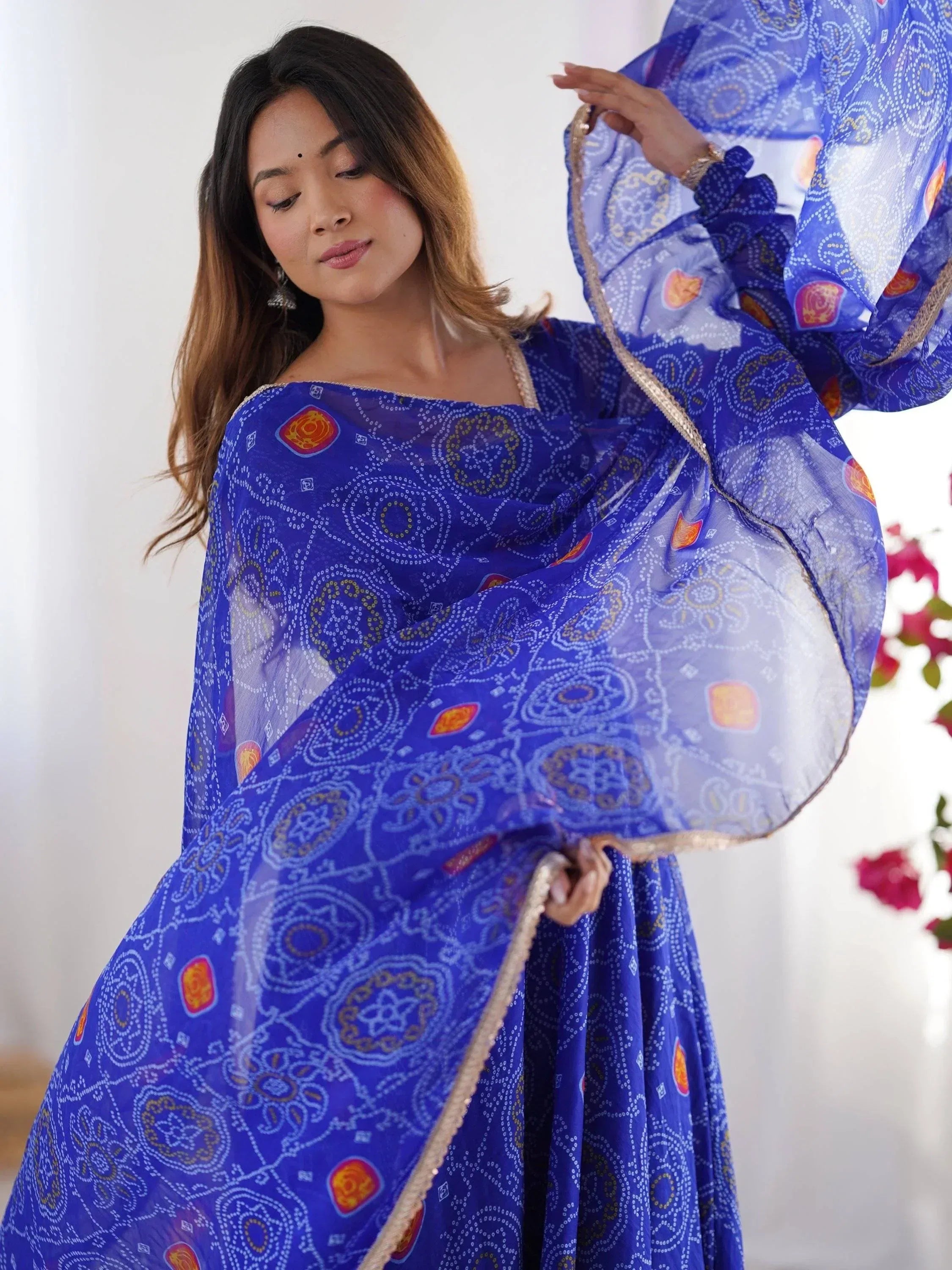 Blue printed ethnic gown with flared sleeves and gold trim, perfect for Indian occasions