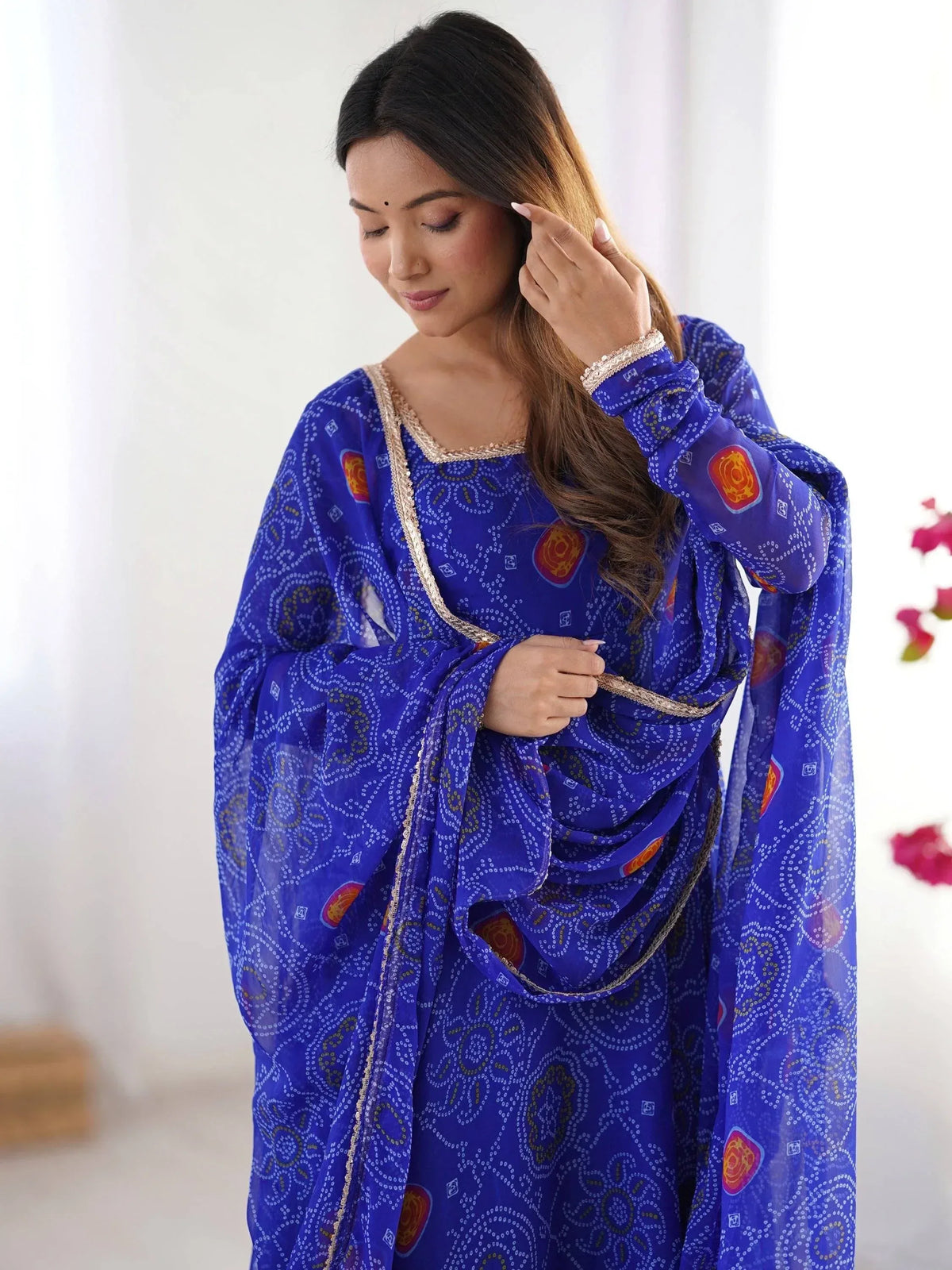 Woman in blue printed ethnic salwar kameez with gold trim, stylish Indian wear for festive occasions