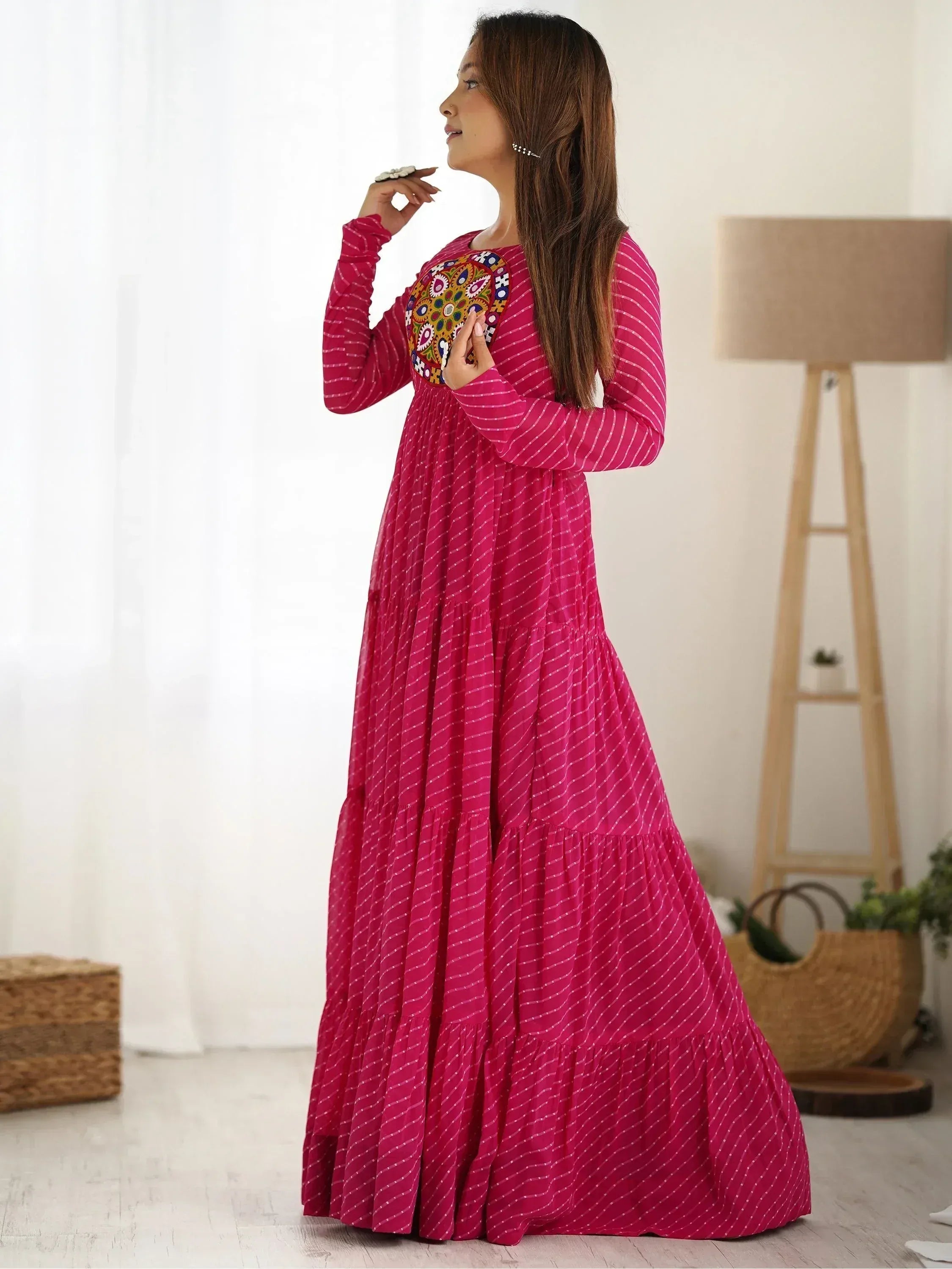 Pink ethnic gown with embroidered yoke and tiered skirt, perfect for Indian festive wear